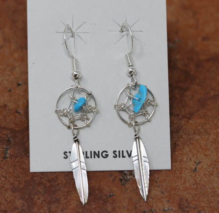 Beautiful Navajo sterling silver dream catcher earrings. The earrings are about 2" in length including the hook and 1/2" wide at the widest point.