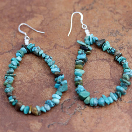 Beautiful Navajo Nugget Earrings. They are made from sterling silver and nuggets. The earrings about 3" long including the hook and 1/4" in width.