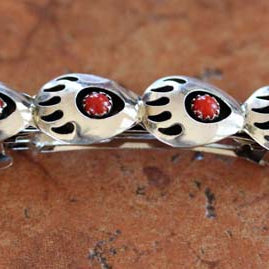 Hair Barrette with four silver bear paws that have a circular coral stone in them