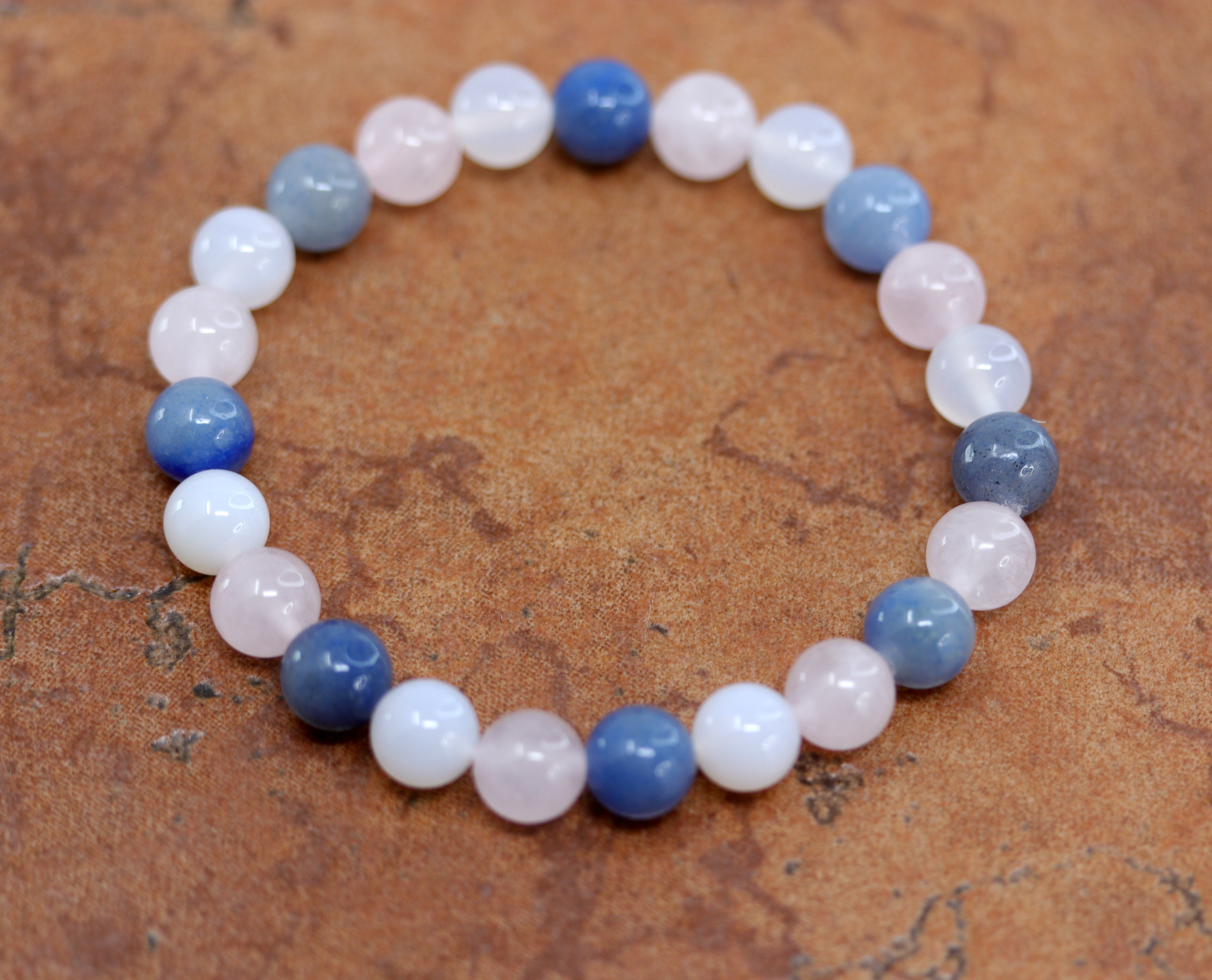 A beautiful bubble bracelet with gemstones. The stones include rose quartz and agate. It fits sizes 6" (more loose) to about 9" (tighter fit). The width of the bracelet is 8 mm.