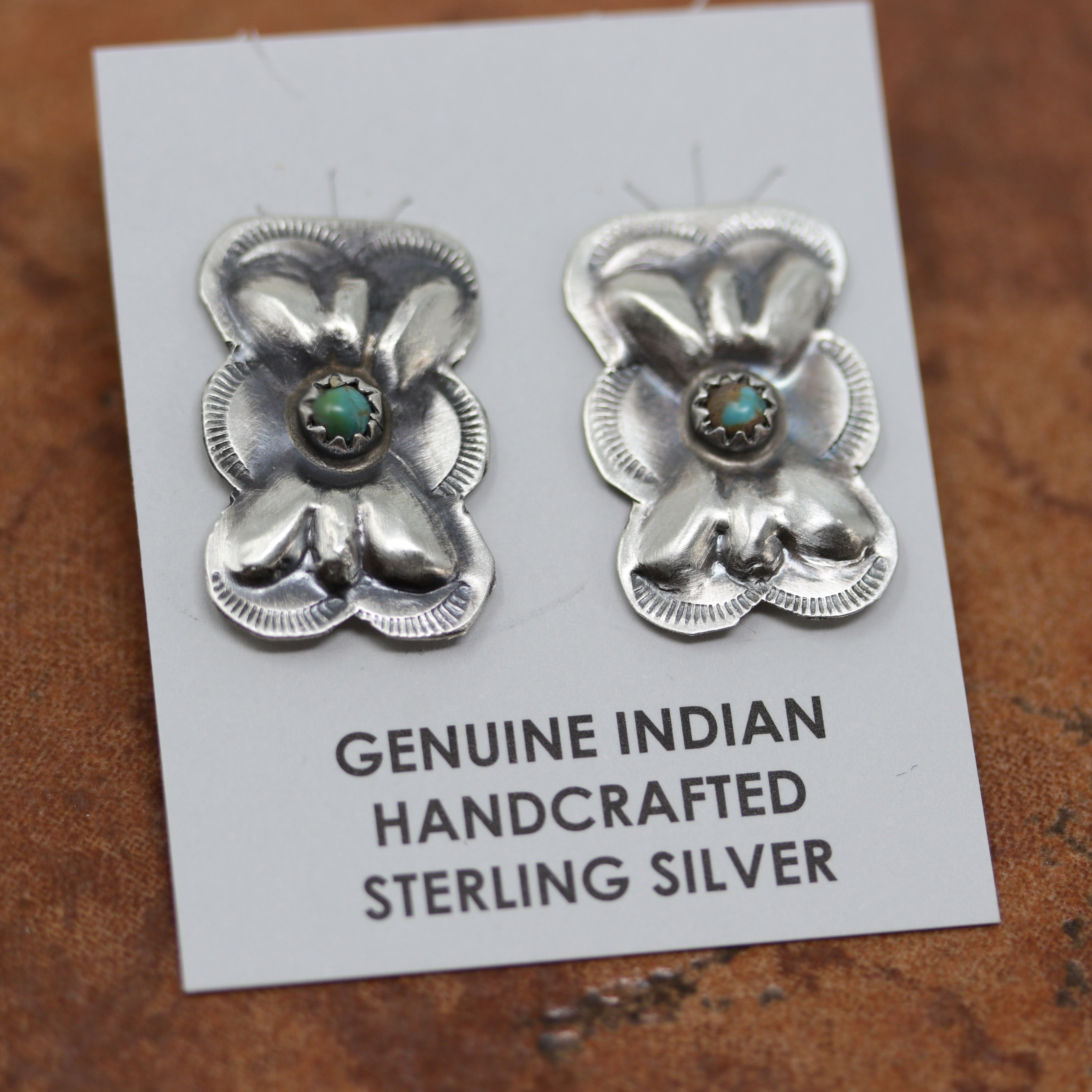 Navajo Native American earrings. They are made from sterling silver and turquoise. The earrings are 1" in length including the hook and 3/4" in width.