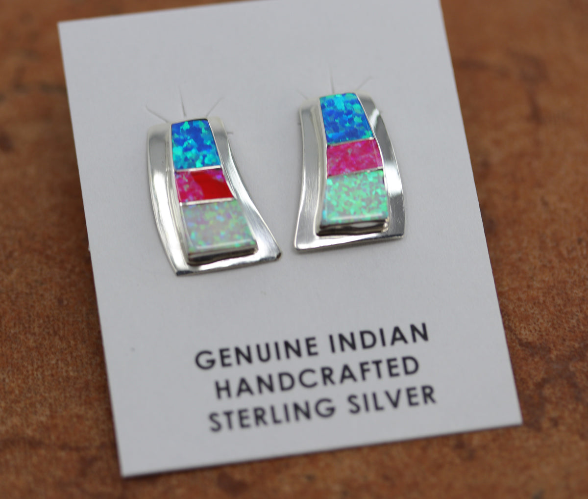 They are made from sterling silver and created opal. Each earring measures about 7/8" in length and 1/2" in width. 