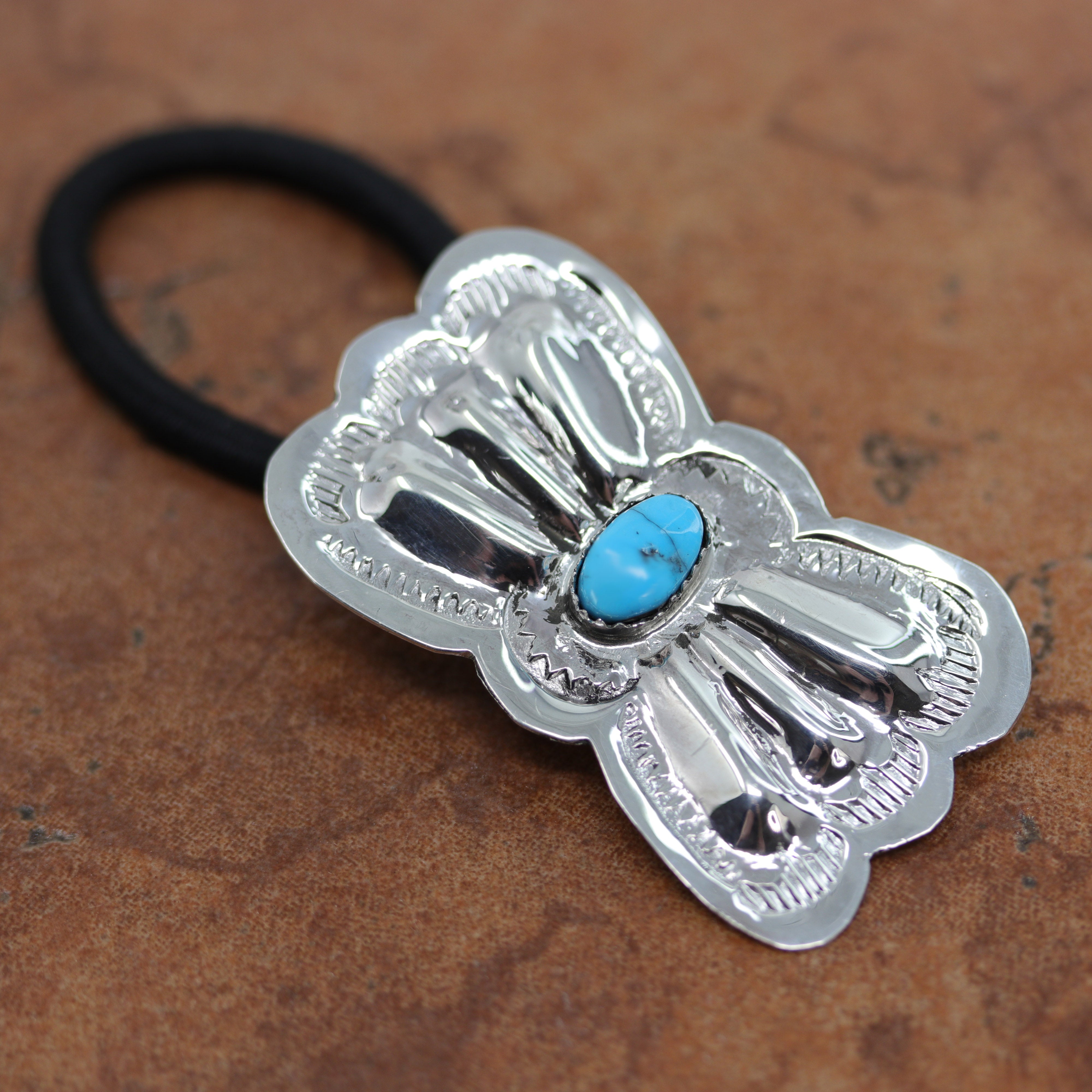 Navajo Native American hair tie made from, a hair band, sterling silver and turquoise. It is 3 1/4" long, and about 1 1/4" in width. 