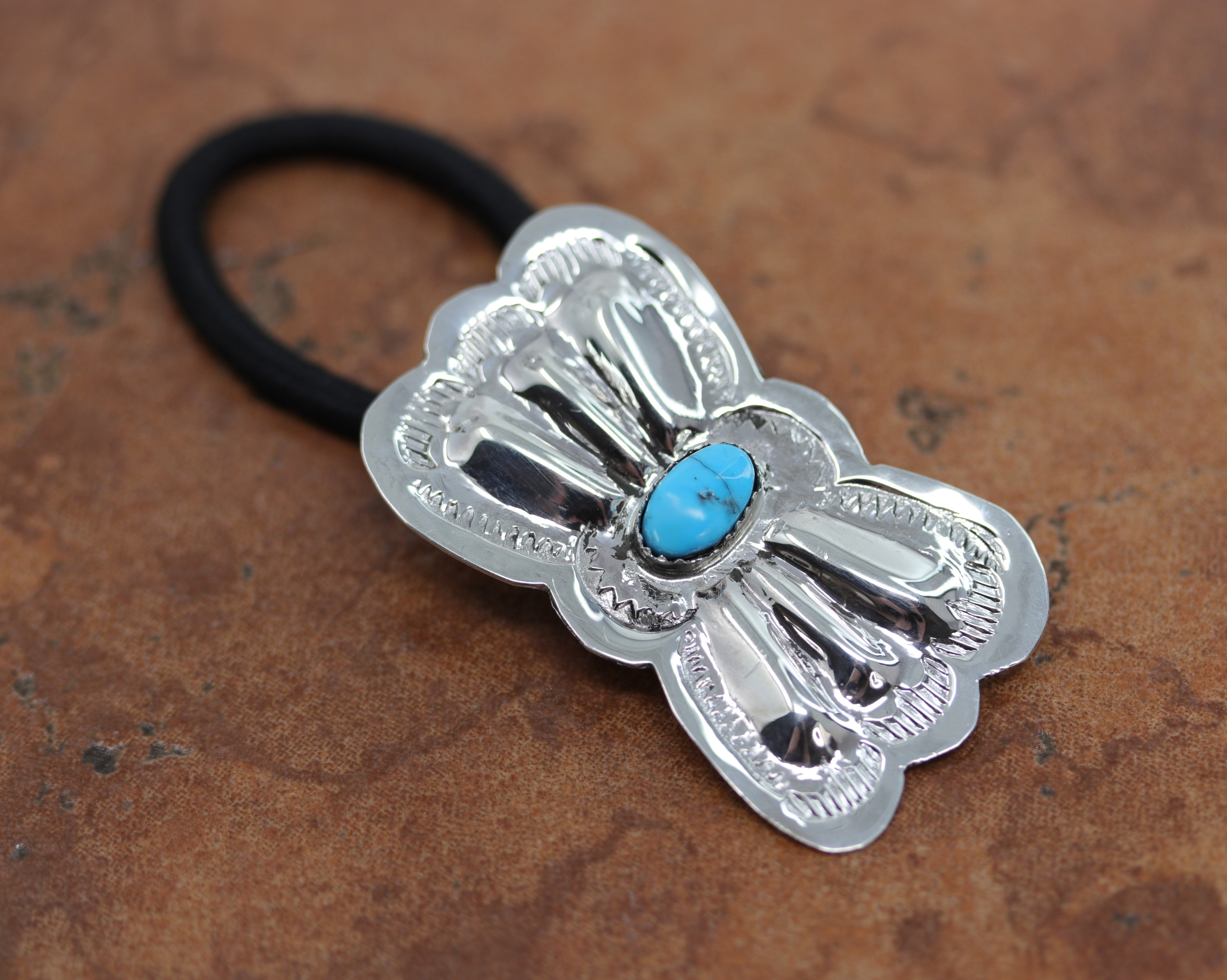 Navajo Native American hair tie made from, a hair band, sterling silver and turquoise. It is 3 1/4" long, and about 1 1/4" in width. 