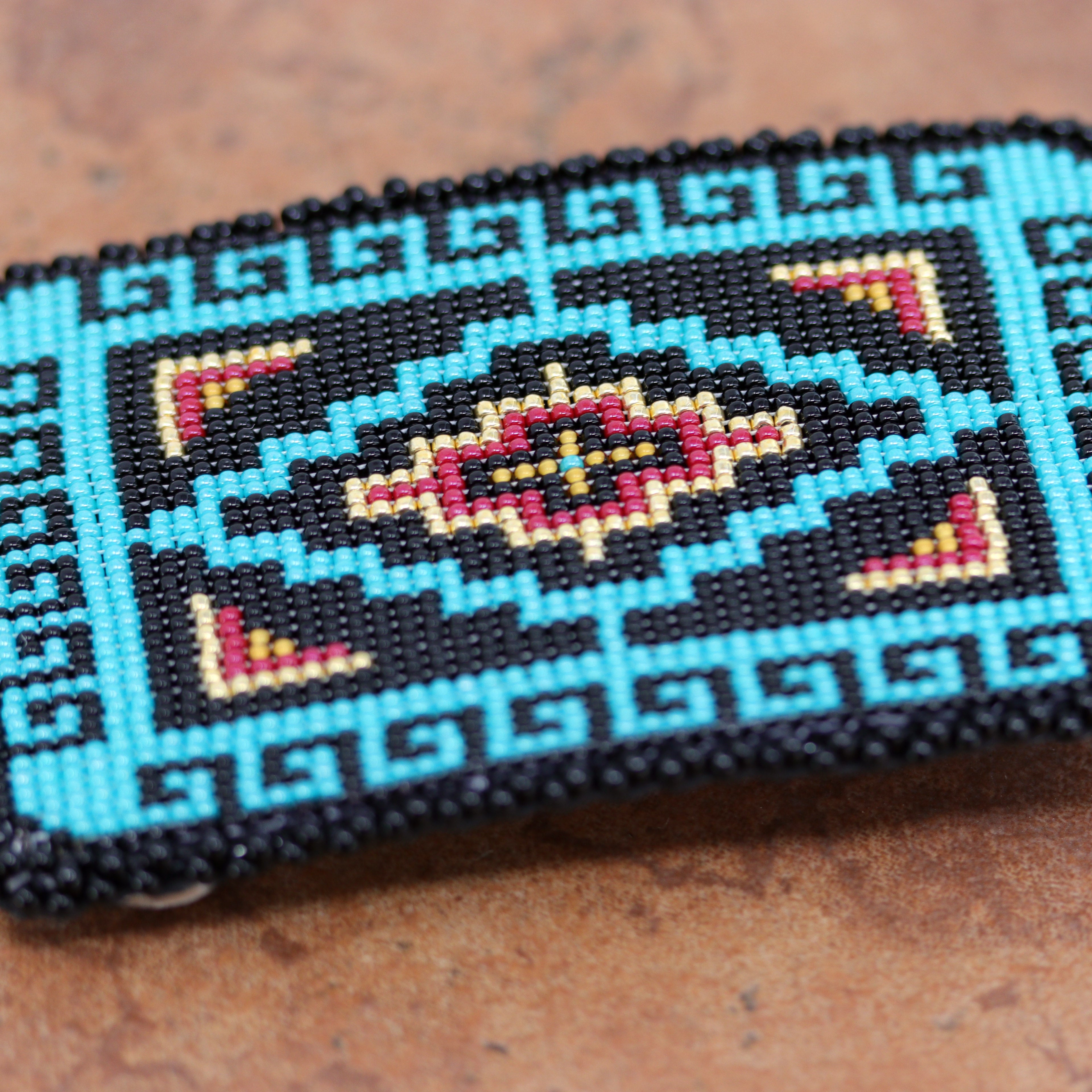 Authentic Navajo Native American Belt Buckle. It is made from sterling silver and mostly blue and black beads. It is about 3 1/2" by 2 1/4". It will hold a belt up to 1 1/2" wide.