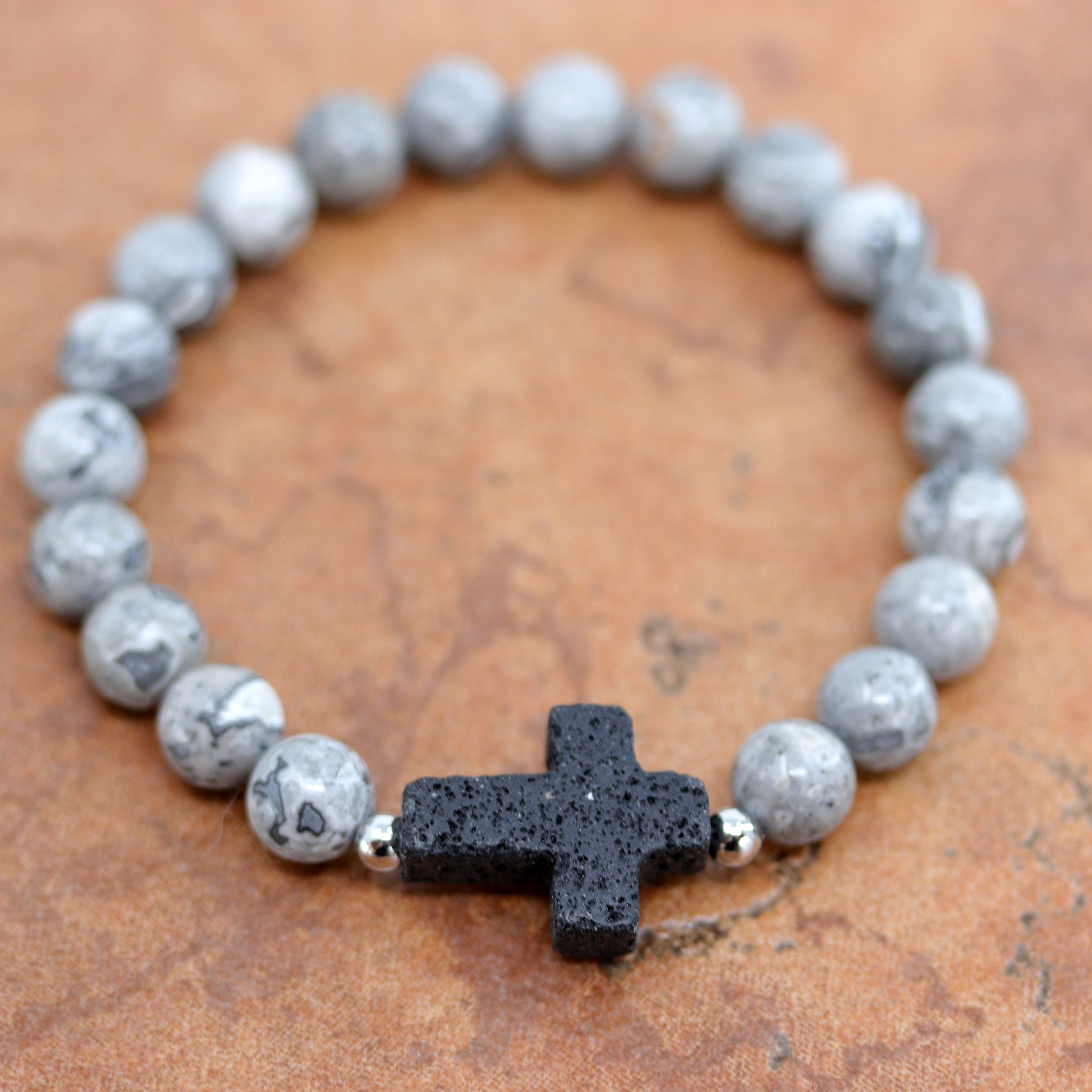 A beautiful beaded black labradorite bubble bracelet with a cross on it. It fits sizes 6" (more loose) to about 9" (tighter fit). The width of the bracelet is 3/8" at the beads, and the cross is 7/8". 