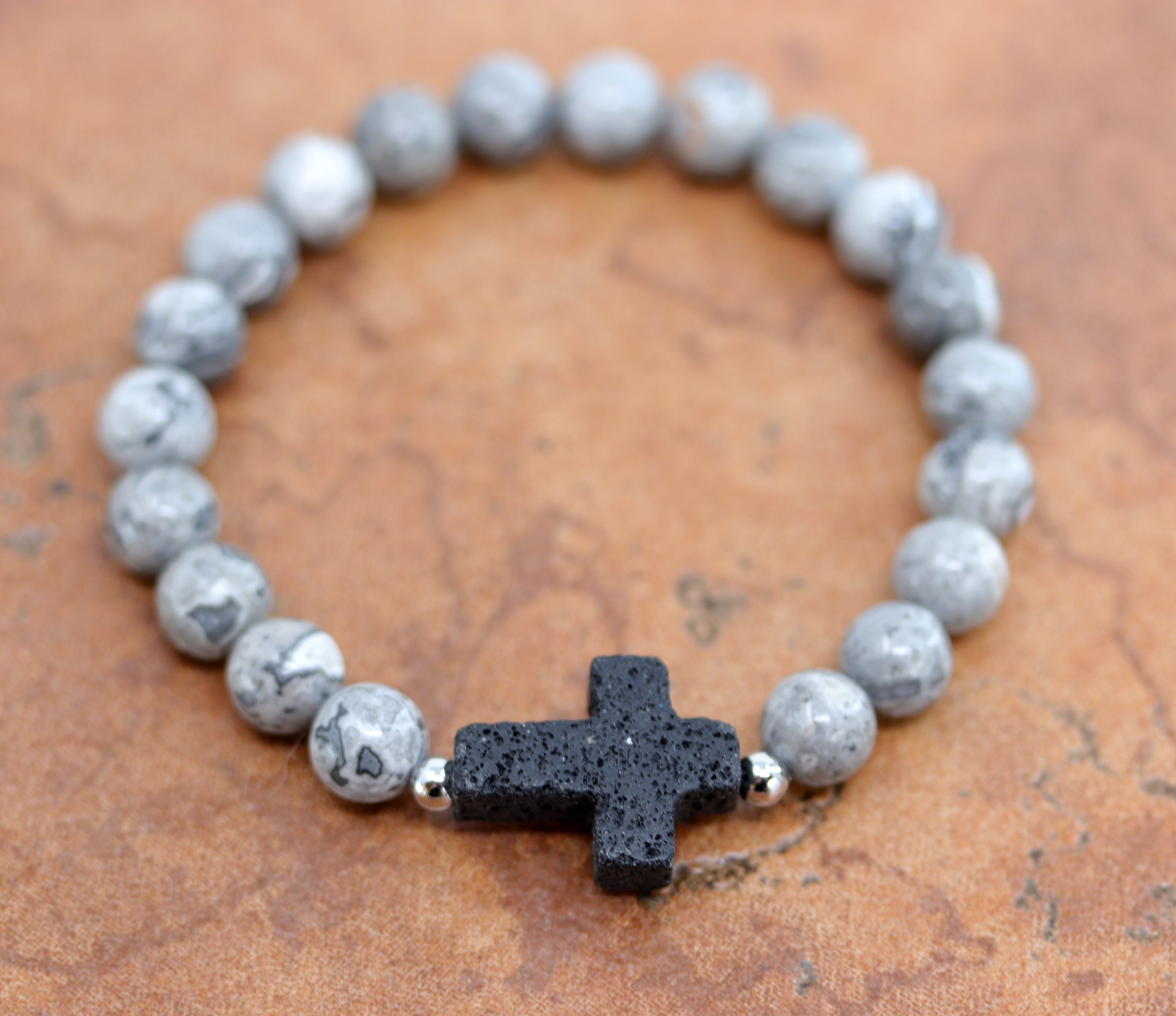 A beautiful beaded black labradorite bubble bracelet with a cross on it. It fits sizes 6" (more loose) to about 9" (tighter fit). The width of the bracelet is 3/8" at the beads, and the cross is 7/8". 