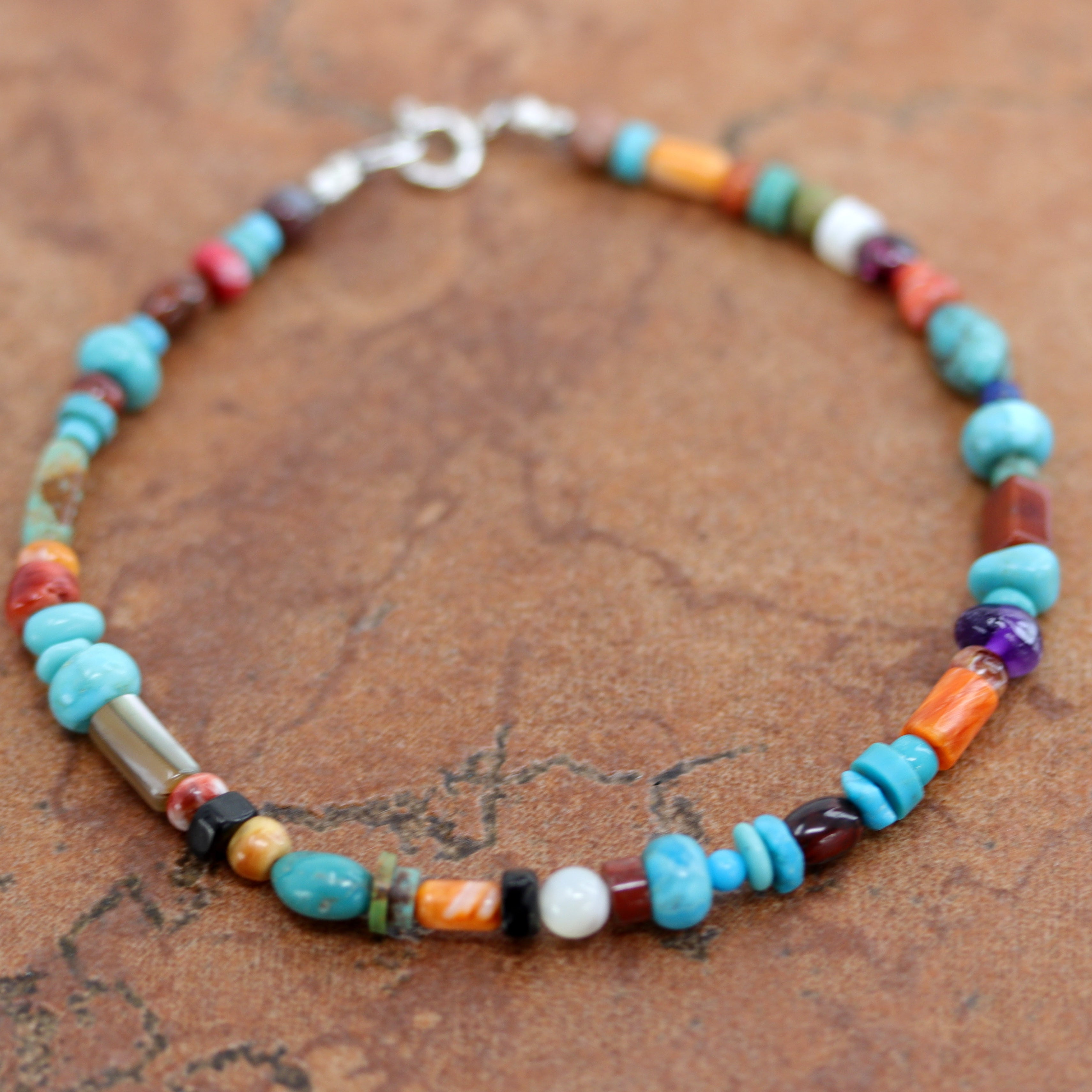 Lovely Navajo Native American Multi-Color Nugget Bracelet. It is about 8 1/4" from end to end and the width is 5/16" at the widest point.