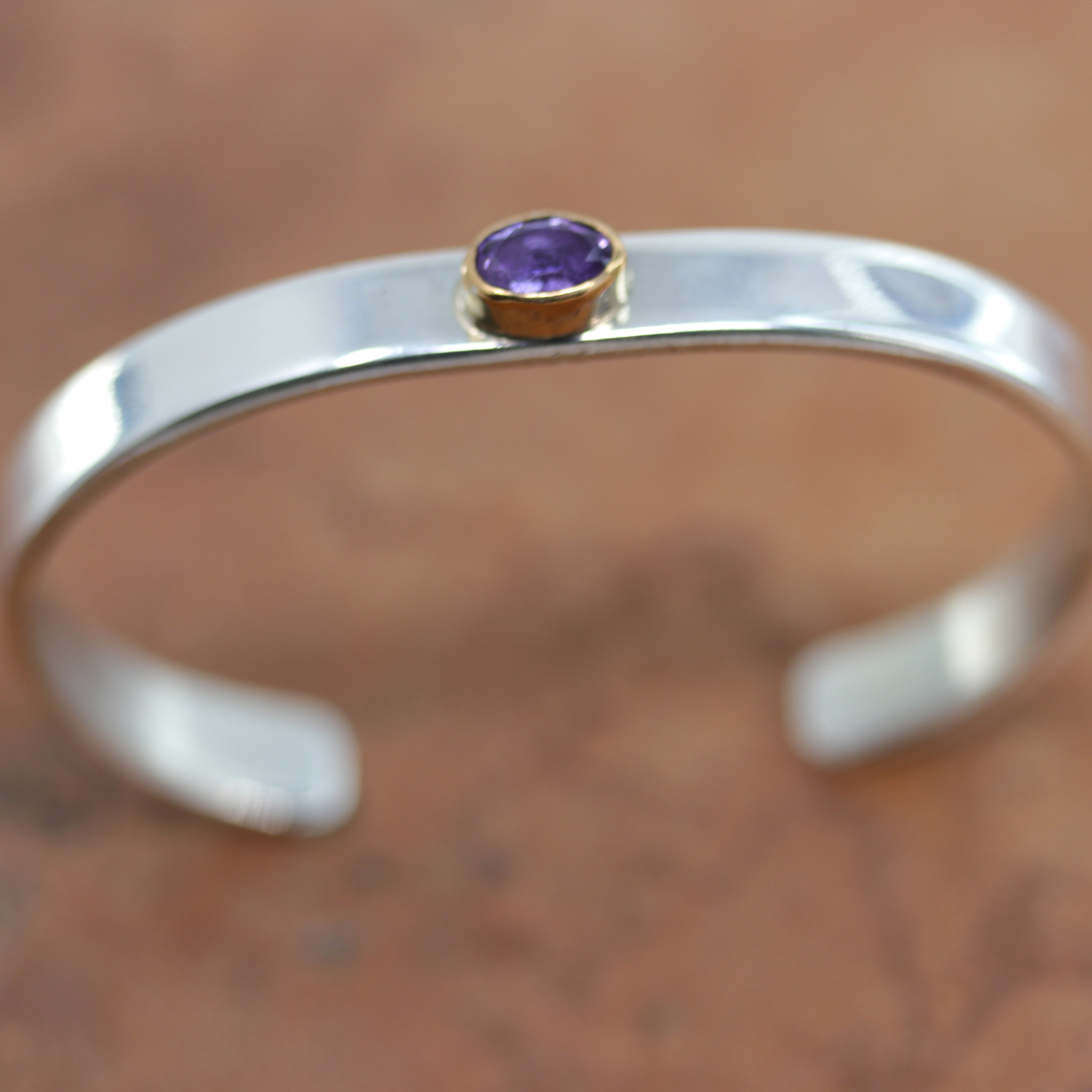 Beautiful Navajo Native American bracelet. It is made from sterling silver and amethyst. It is about 5" around and 1/4" wide. The opening is about 1", and partly flexible.