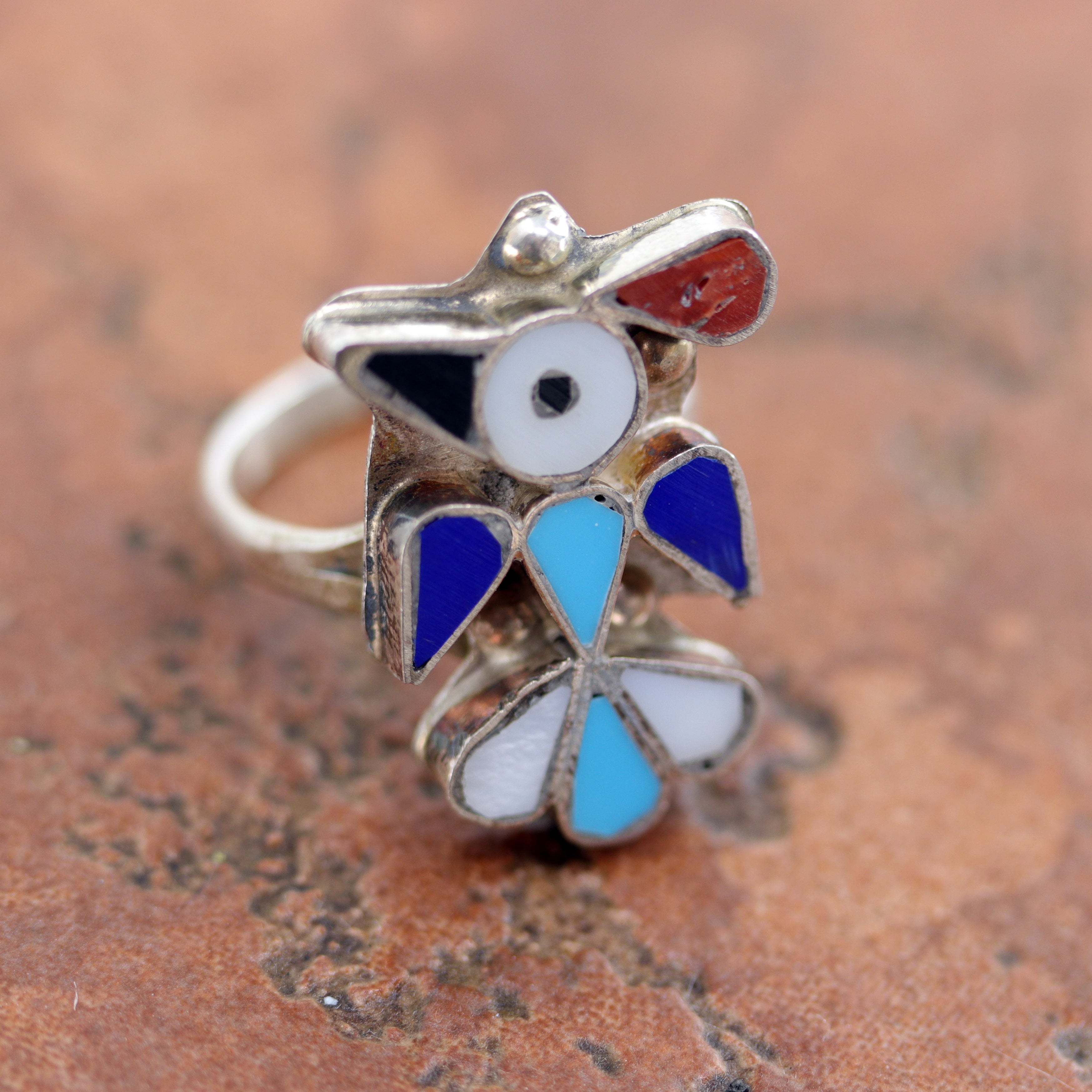 Lovely Zuni Native American Thunderbird ring. It is made from sterling silver and multi-stone inlay. The ring size 6 and it is 1" in length.