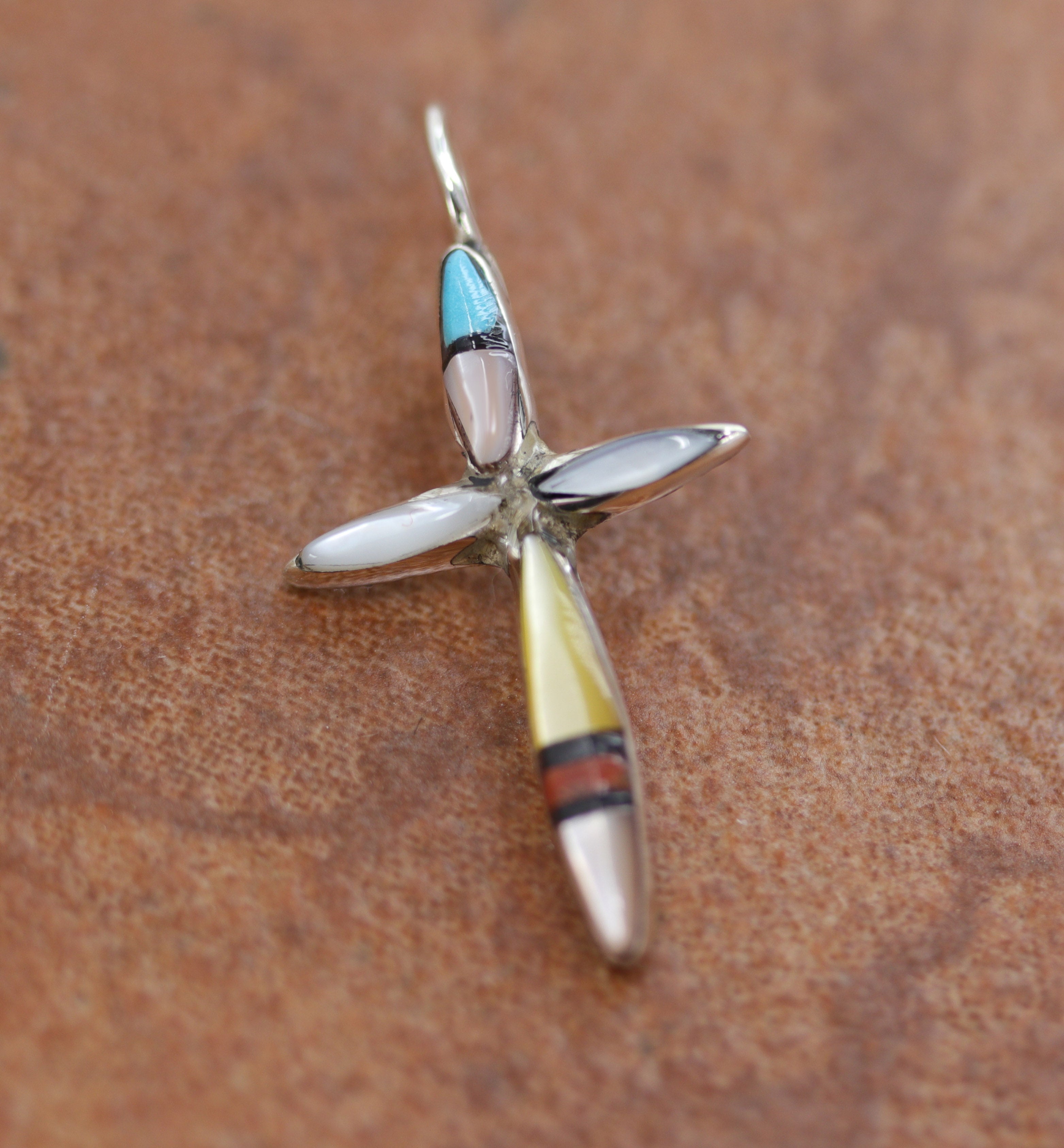 An authentic Zuni Native American Pendant. It is made from Sterling Silver and gemstones. It is about 1 1/4" in length including the bail, and about 3/4" in width. 