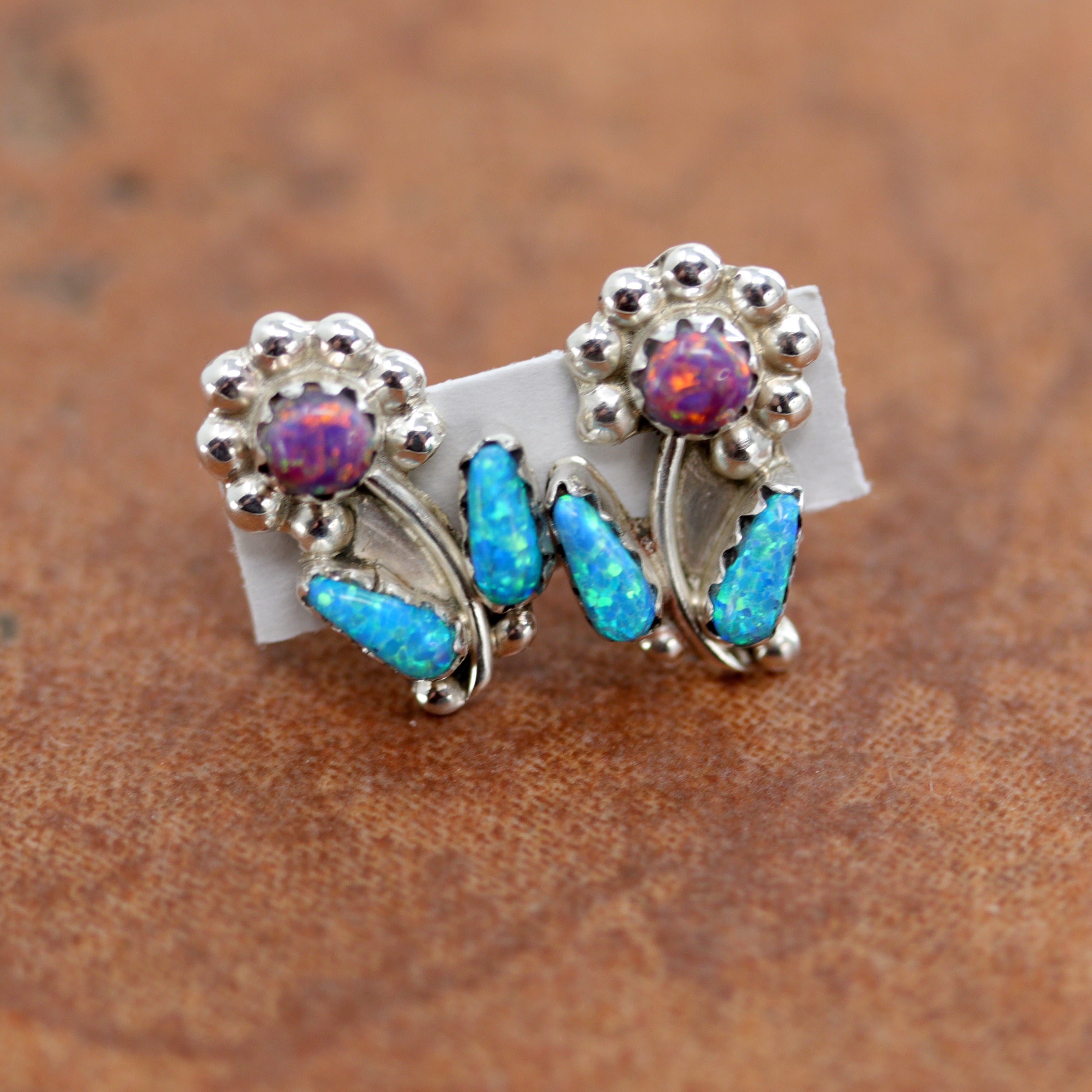 Beautiful Zuni Native American earrings. They are made from sterling silver and created opal. Each earring is 5/8" in length, and about 3/8" in width.