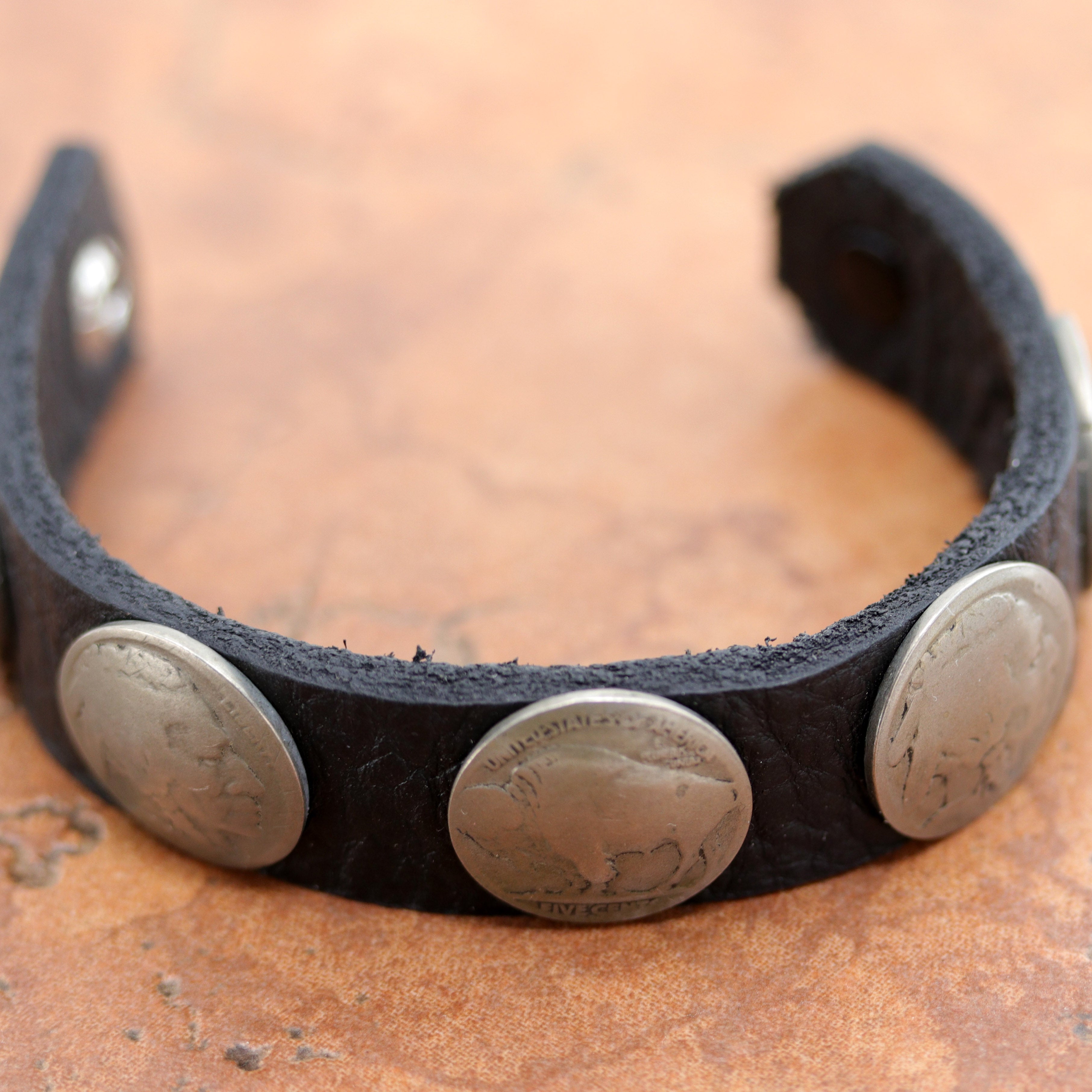 Lovely Navajo Native American leather bracelet. It is made from leather and buffalo nickels. It is about 7 1/2" in length and 3/4" wide.