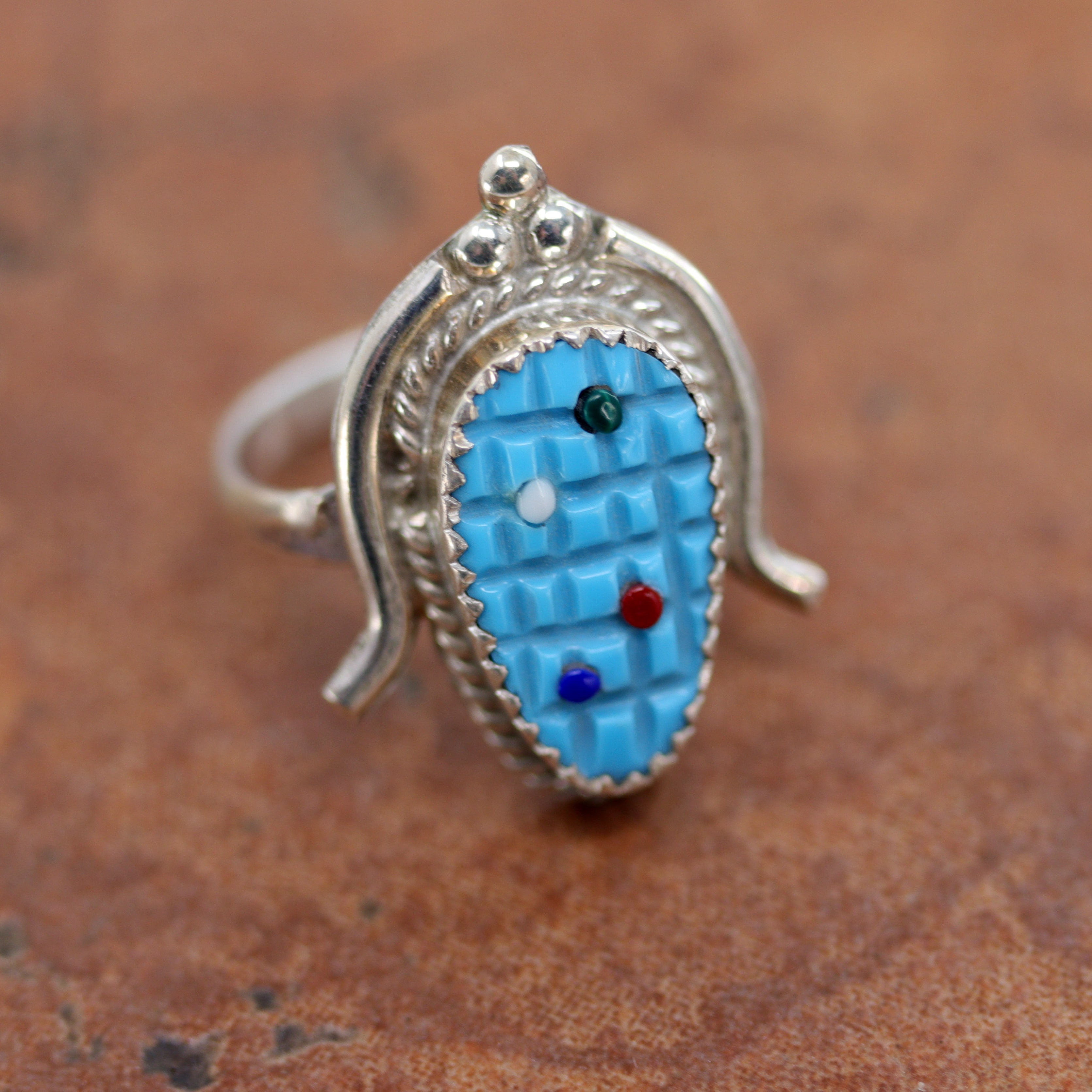Beautiful Zuni Native American ring. It is made from sterling silver and multi-stone. The ring size 7 1/2 and it is 1" in length. 