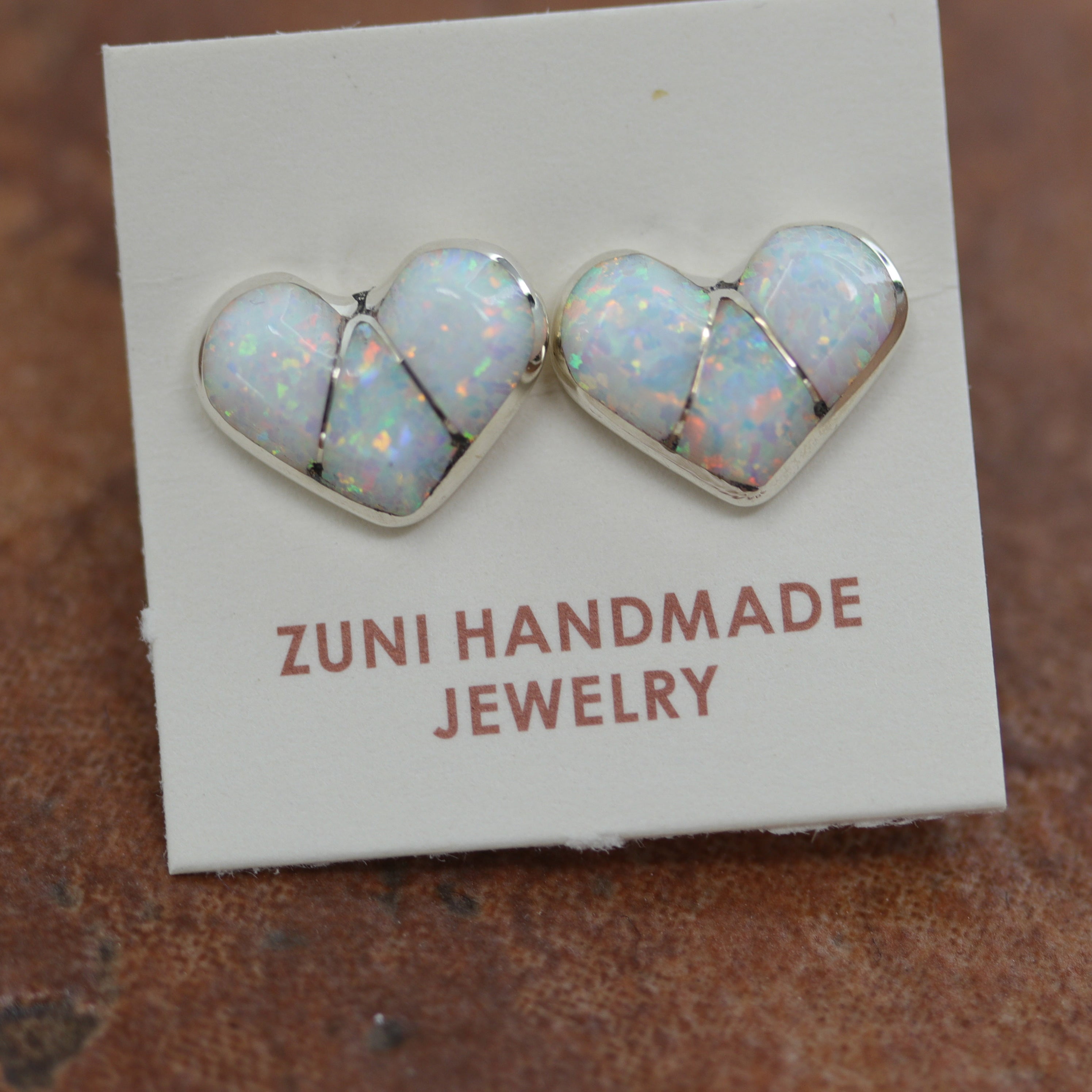 Beautiful Zuni Native American heart earrings. They are made from sterling silver and created opal. Each earring is 3/8" in length, and about 3/8" in width.