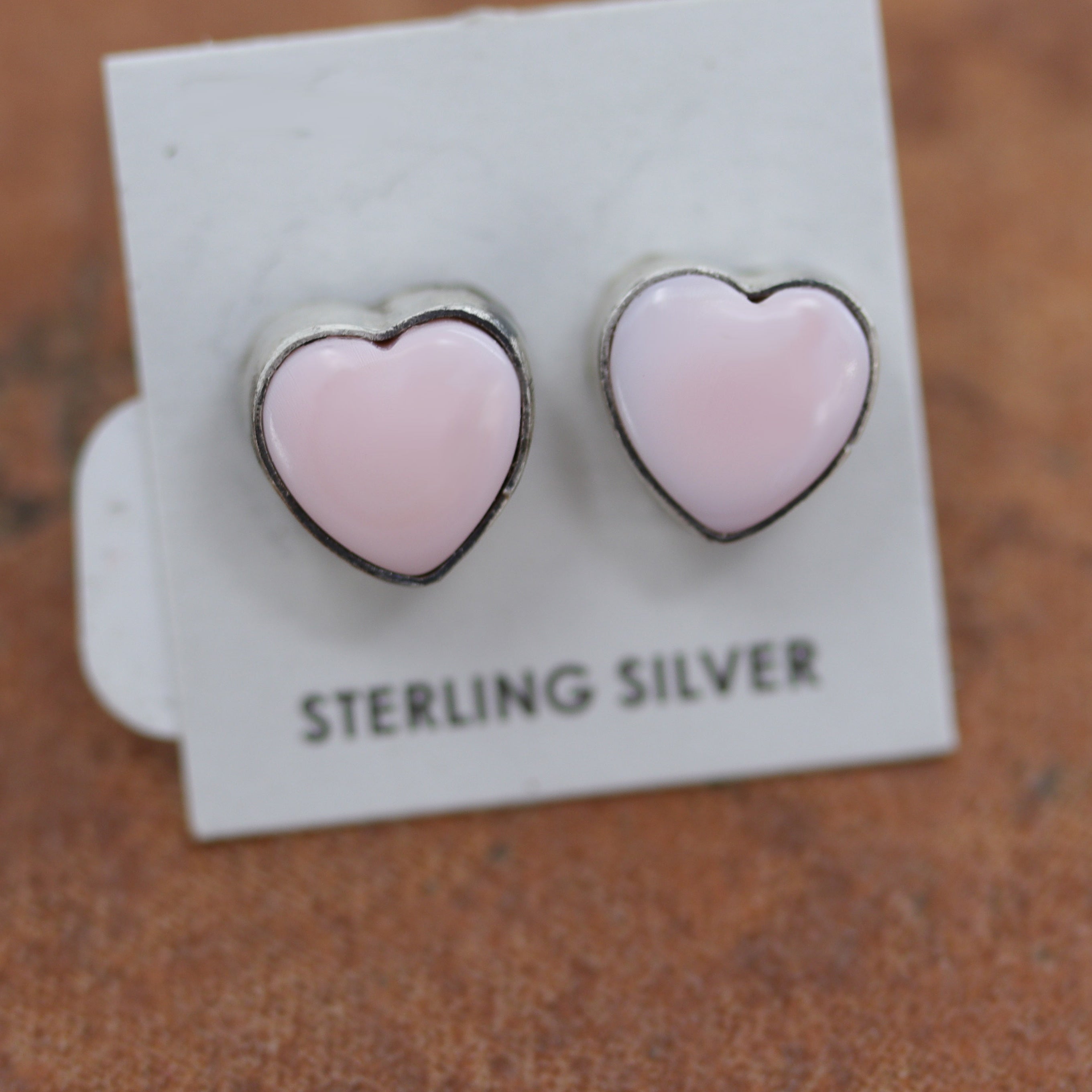 Beautiful Navajo stud heart earrings. They are made from sterling silver and pink quartz. The earrings are 3/8" in length.