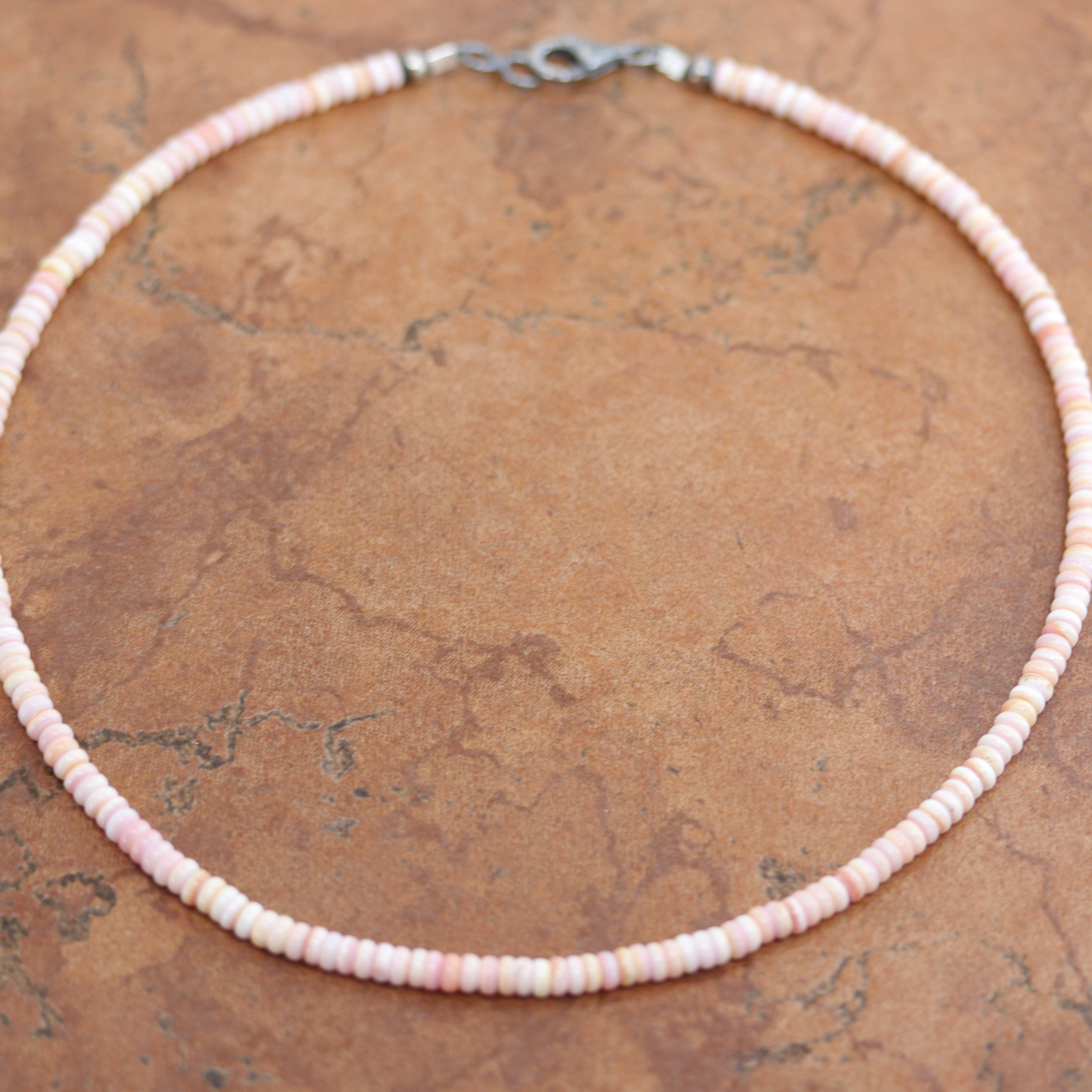 A beautiful silver Navajo Pearl Pink Heishi choker necklace. The necklace is 16 1/2" in length and the beads measure 4 mm.