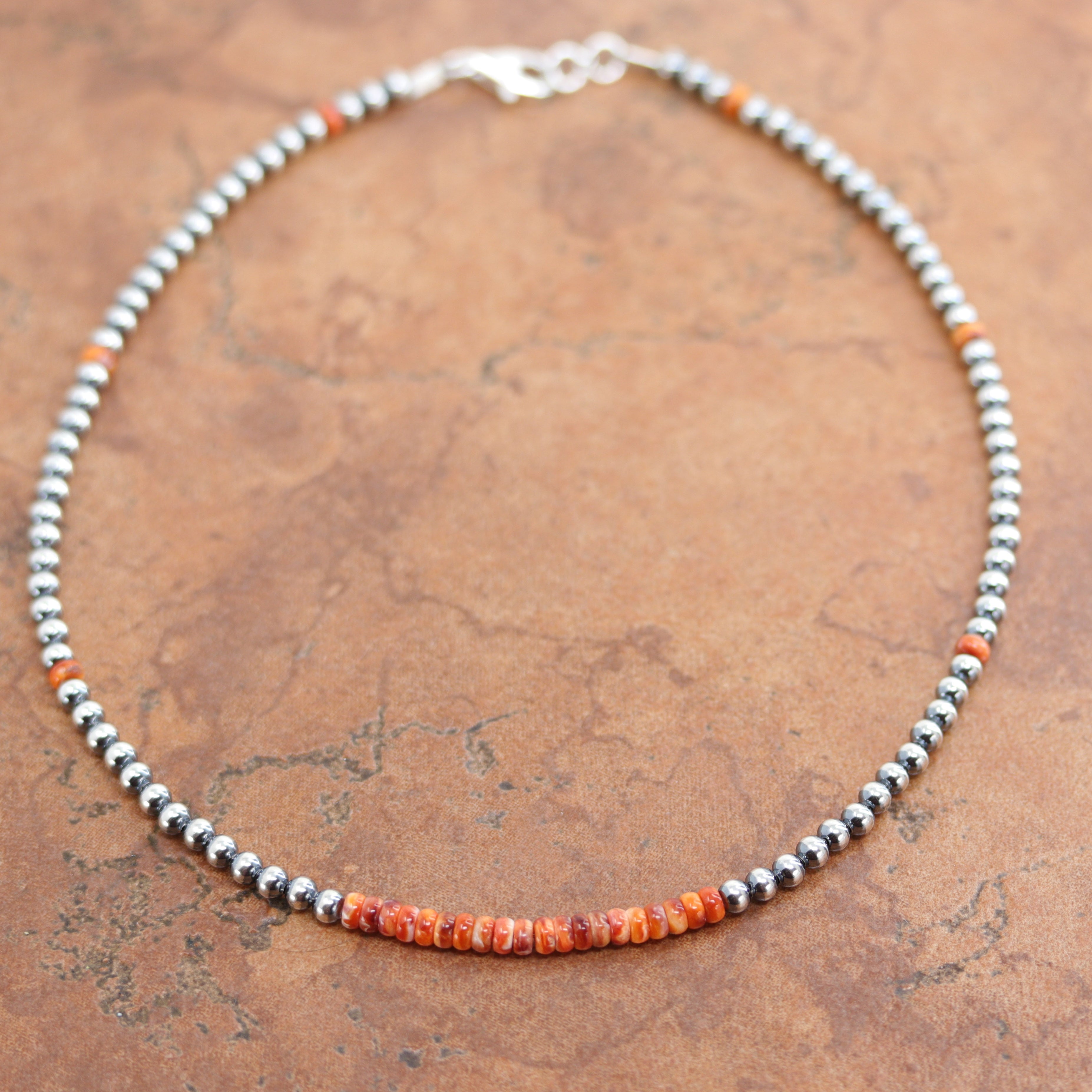 A beautiful silver Navajo Pearl choker necklace with spiny oyster heishi. The necklace is 16" in length and the beads measure 4 mm.