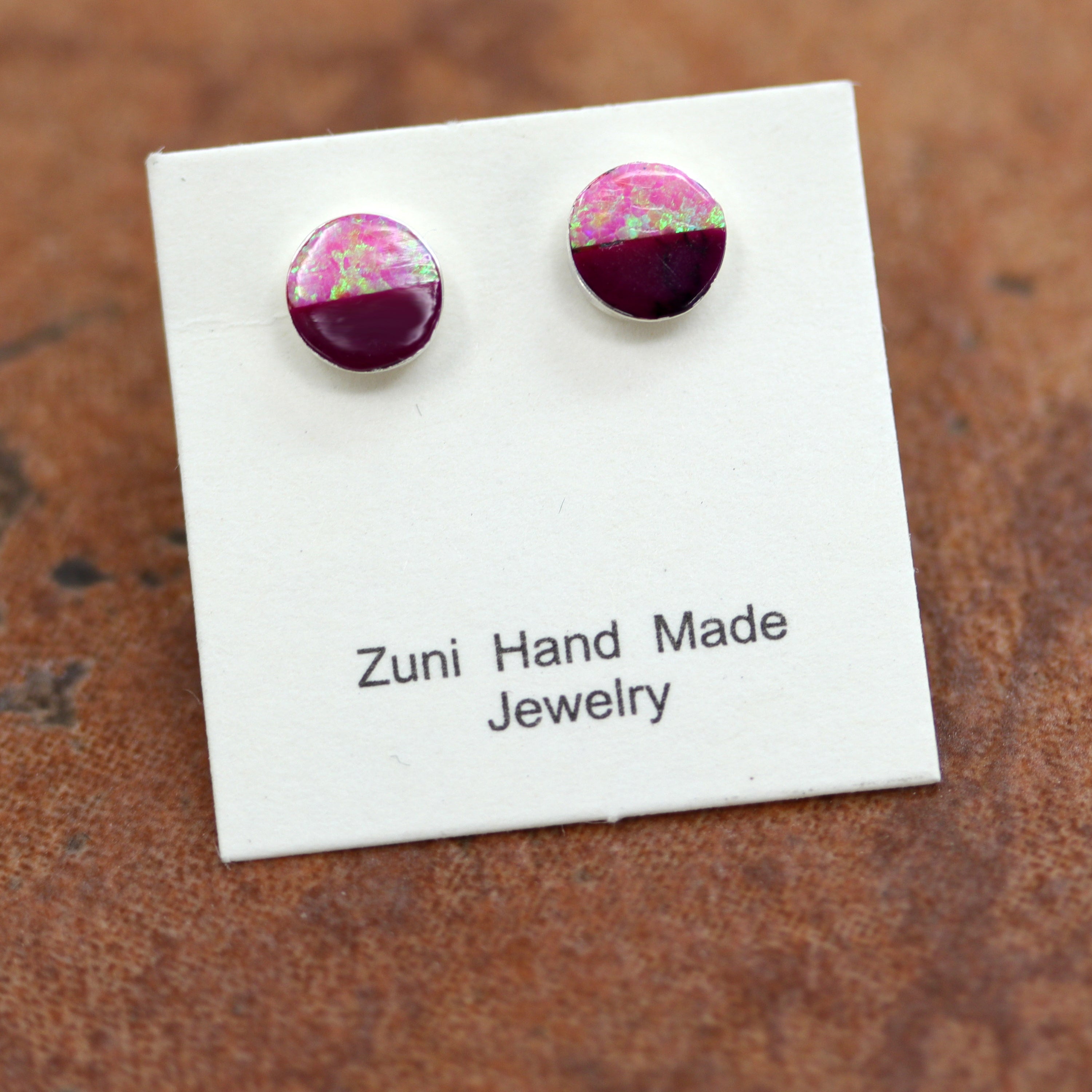 They are made from sterling silver, sugilite, and created opal. The earrings are about 3/16" in diameter.