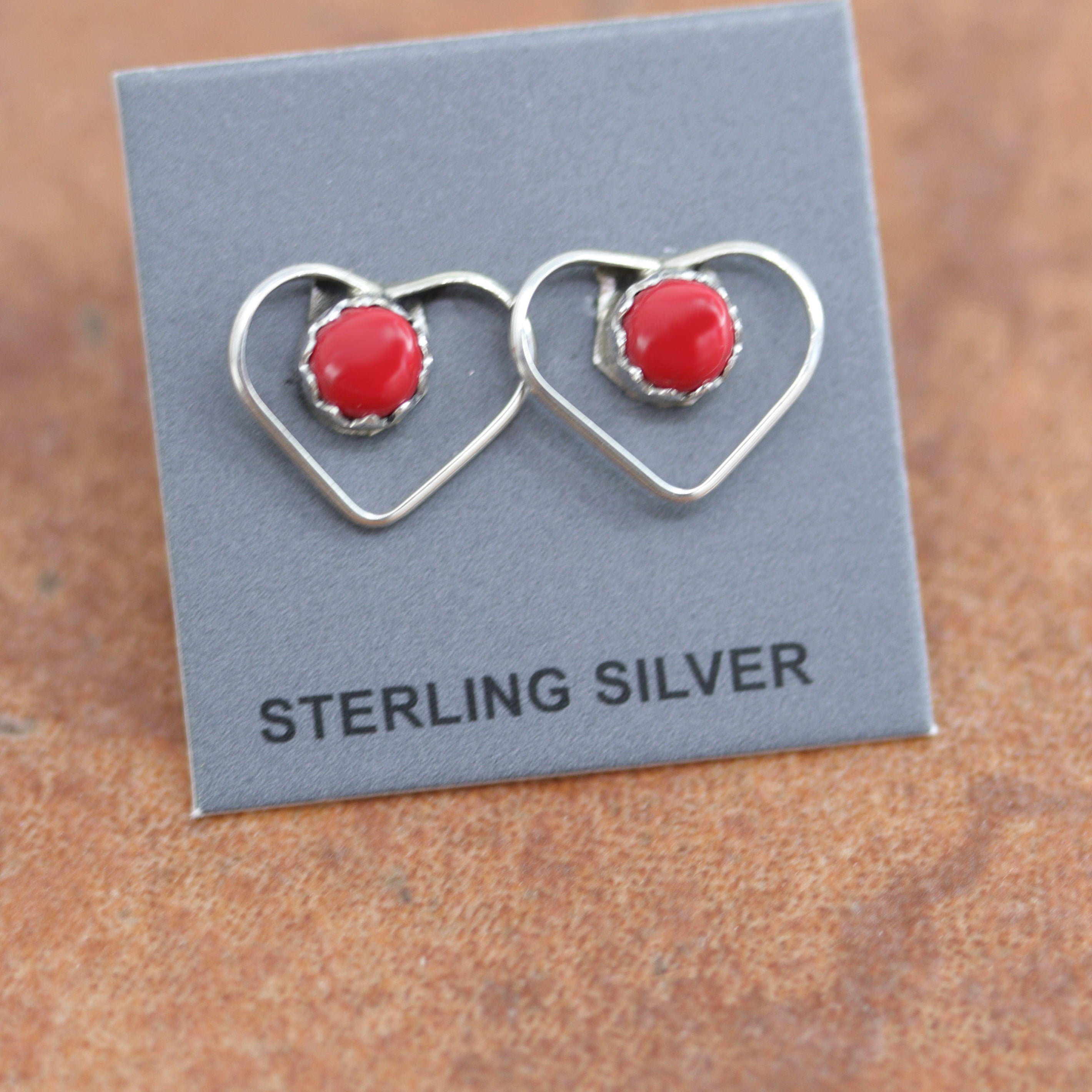 Beautiful Navajo sterling silver and coral heart earrings. The earrings are about 1/2" in length and 3/8" wide at the widest point. 