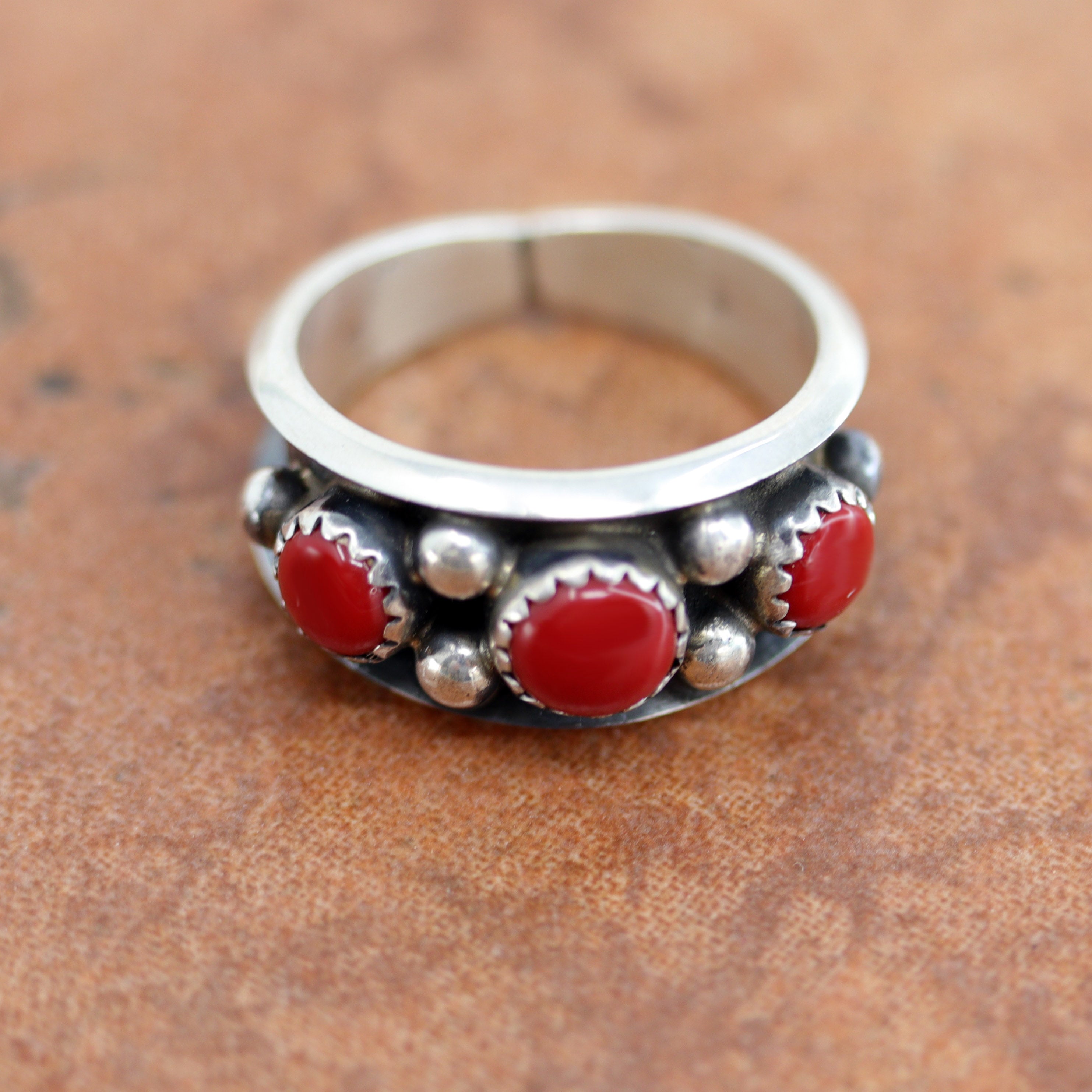 A lovely Navajo Native American ring. It is made from sterling silver and coral. The ring size 7 1/2 and it is 7/16" in length.