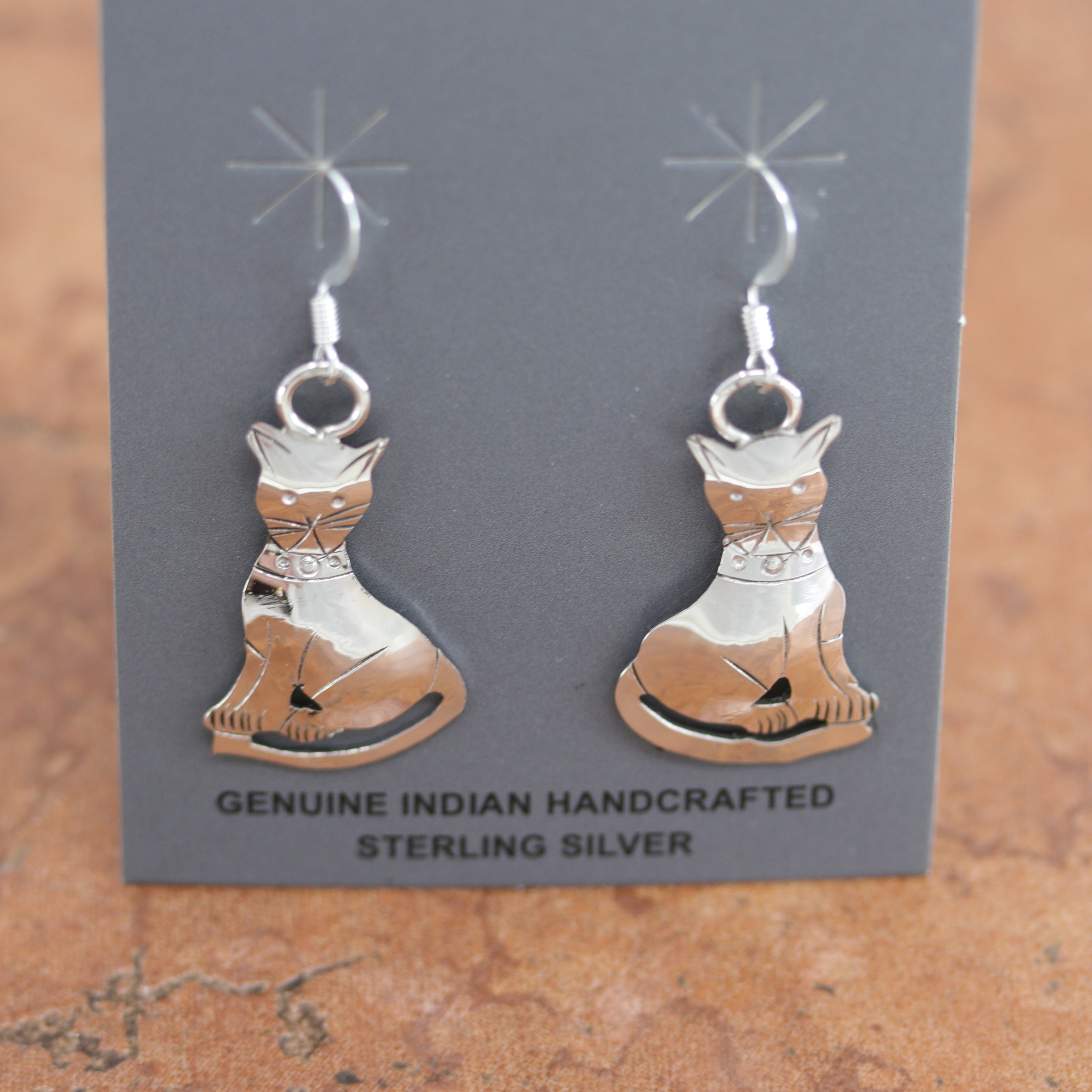Native American earrings. They are made from sterling silver. The earrings are about 1 5/8" in length including the hook and 1 3/4" wide.