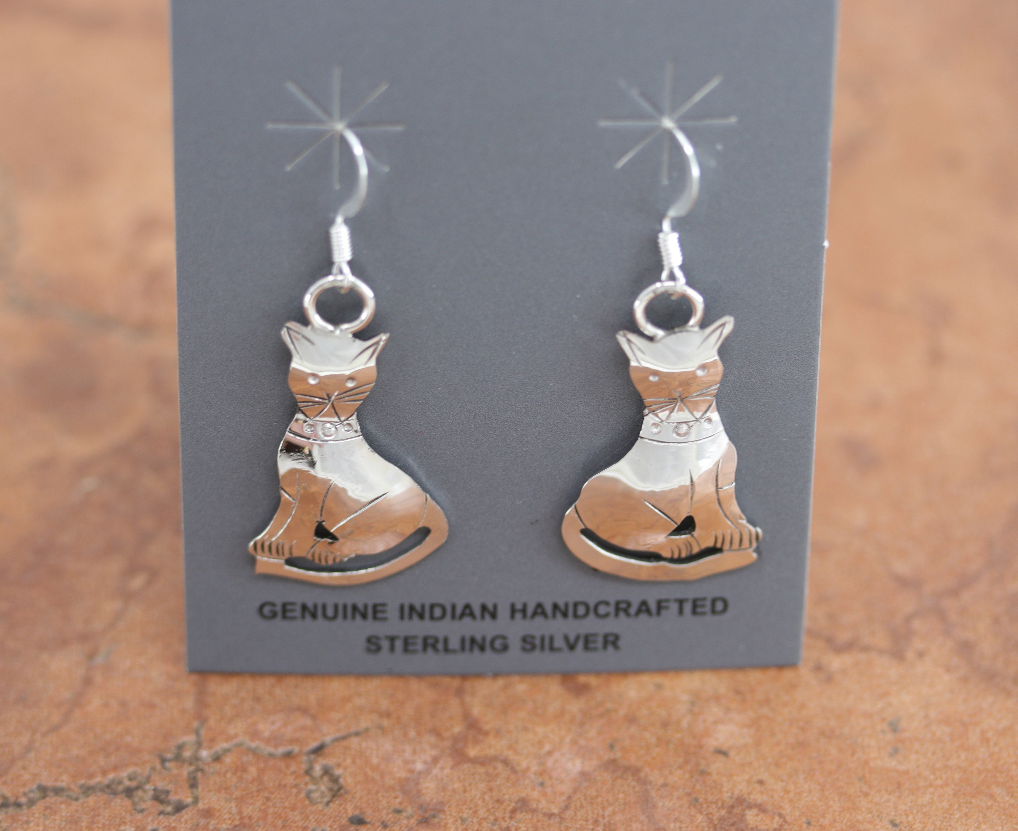 Native American earrings. They are made from sterling silver. The earrings are about 1 5/8" in length including the hook and 1 3/4" wide.