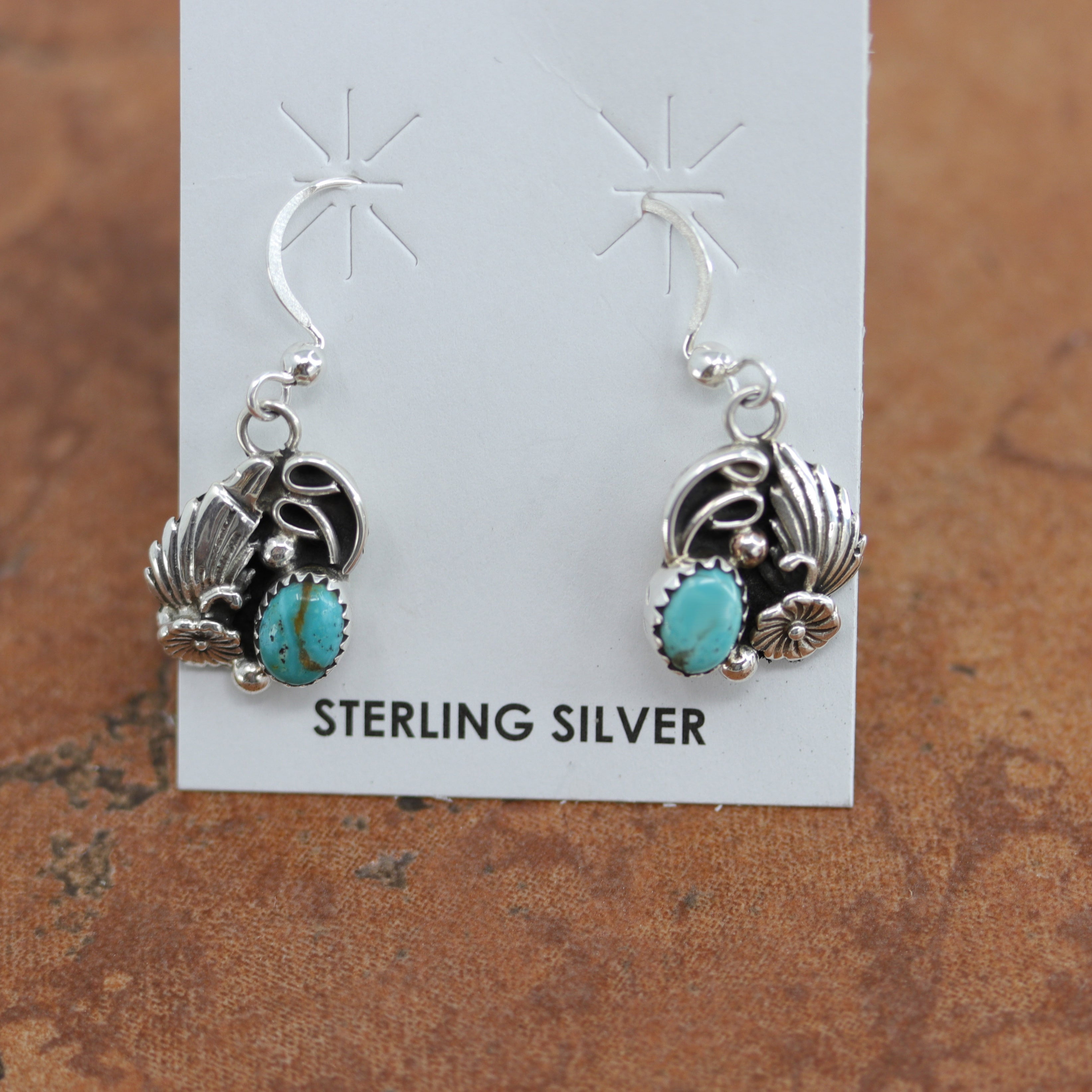 Beautiful Navajo Native American earrings. They are made from sterling silver and turquoise. The earrings are about 1 1/4" in length, and 5/8" in width.