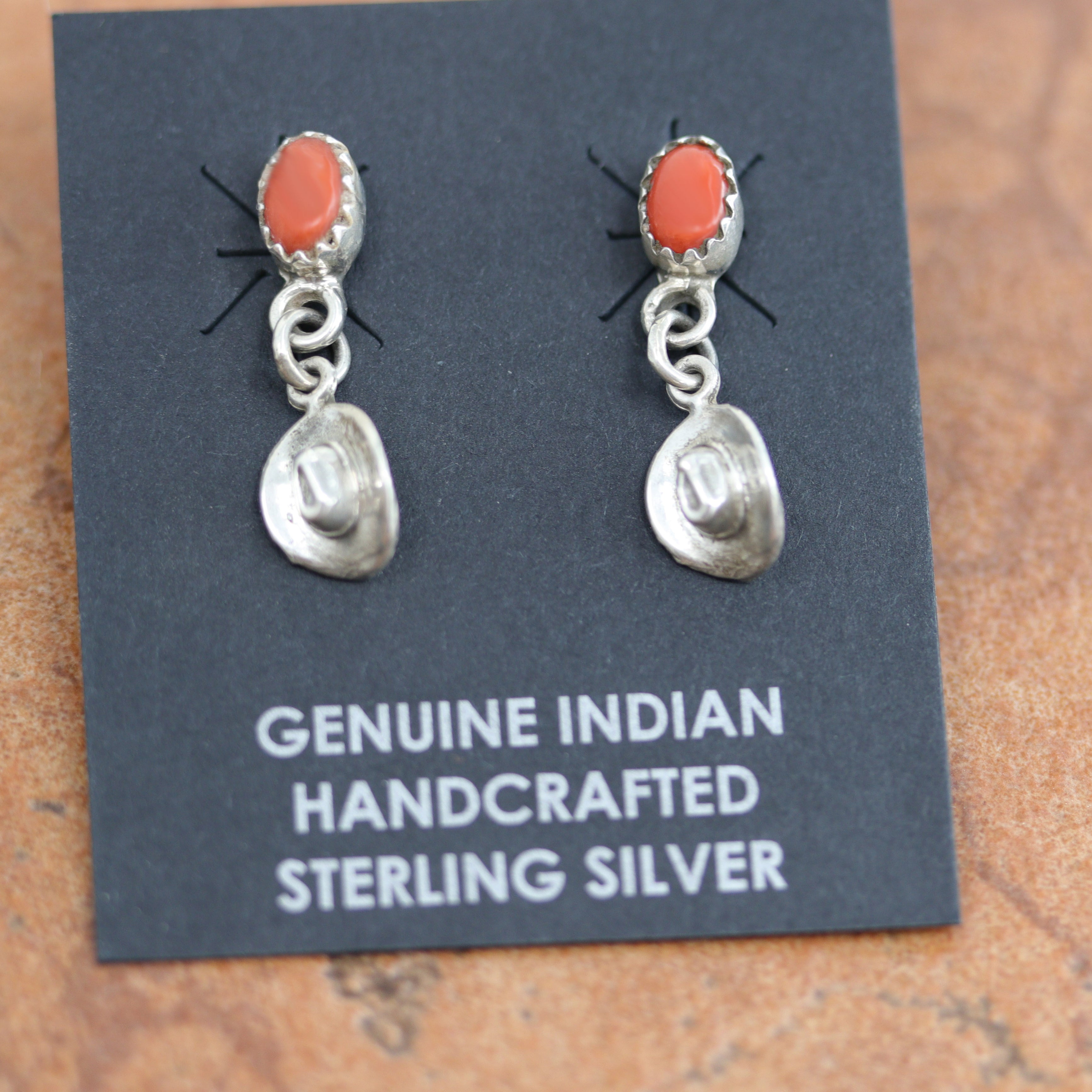 Beautiful Navajo Native American earrings. They are made from sterling silver and coral. The earrings are about 1" in length, and 1/4" in width. 