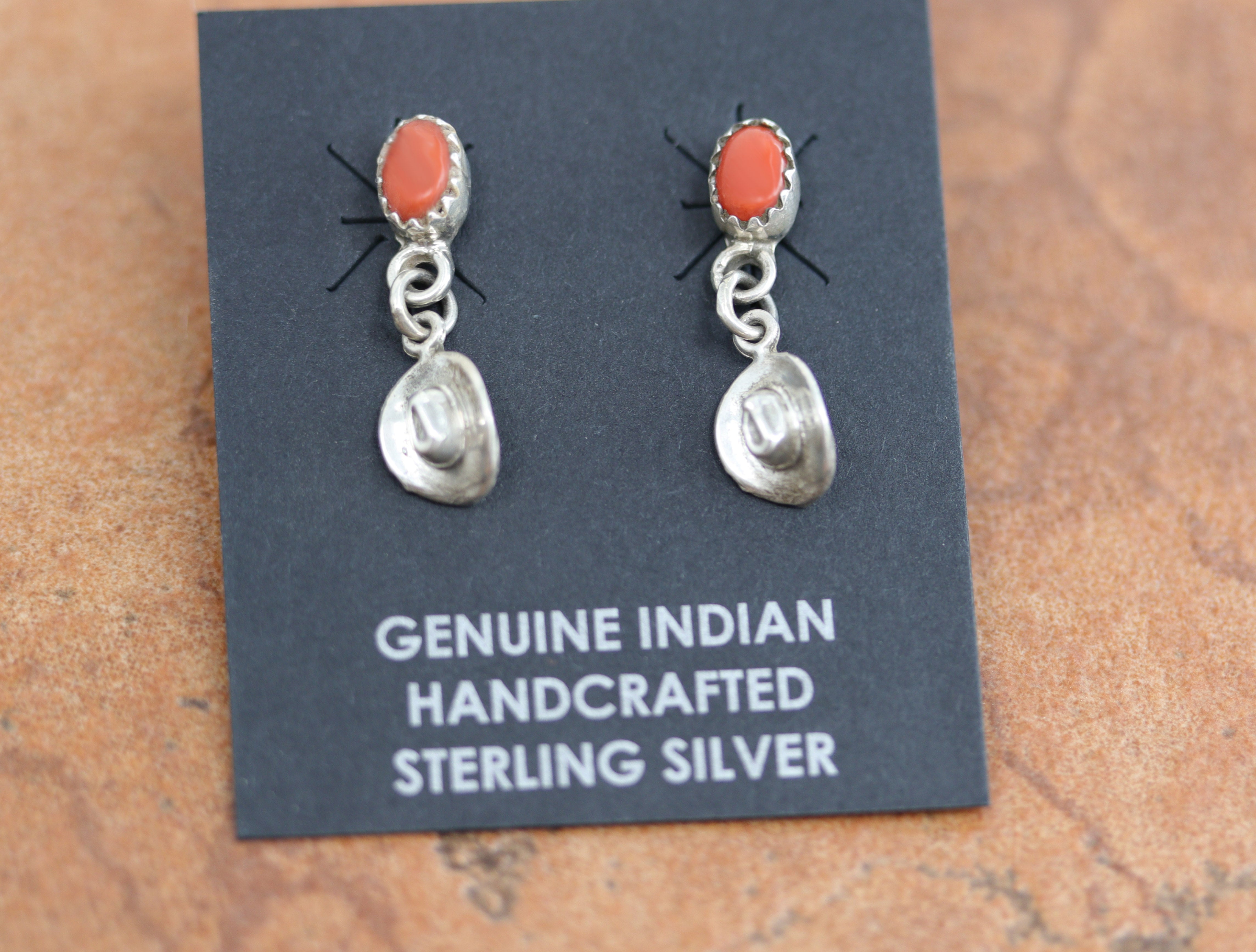 Beautiful Navajo Native American earrings. They are made from sterling silver and coral. The earrings are about 1" in length, and 1/4" in width. 