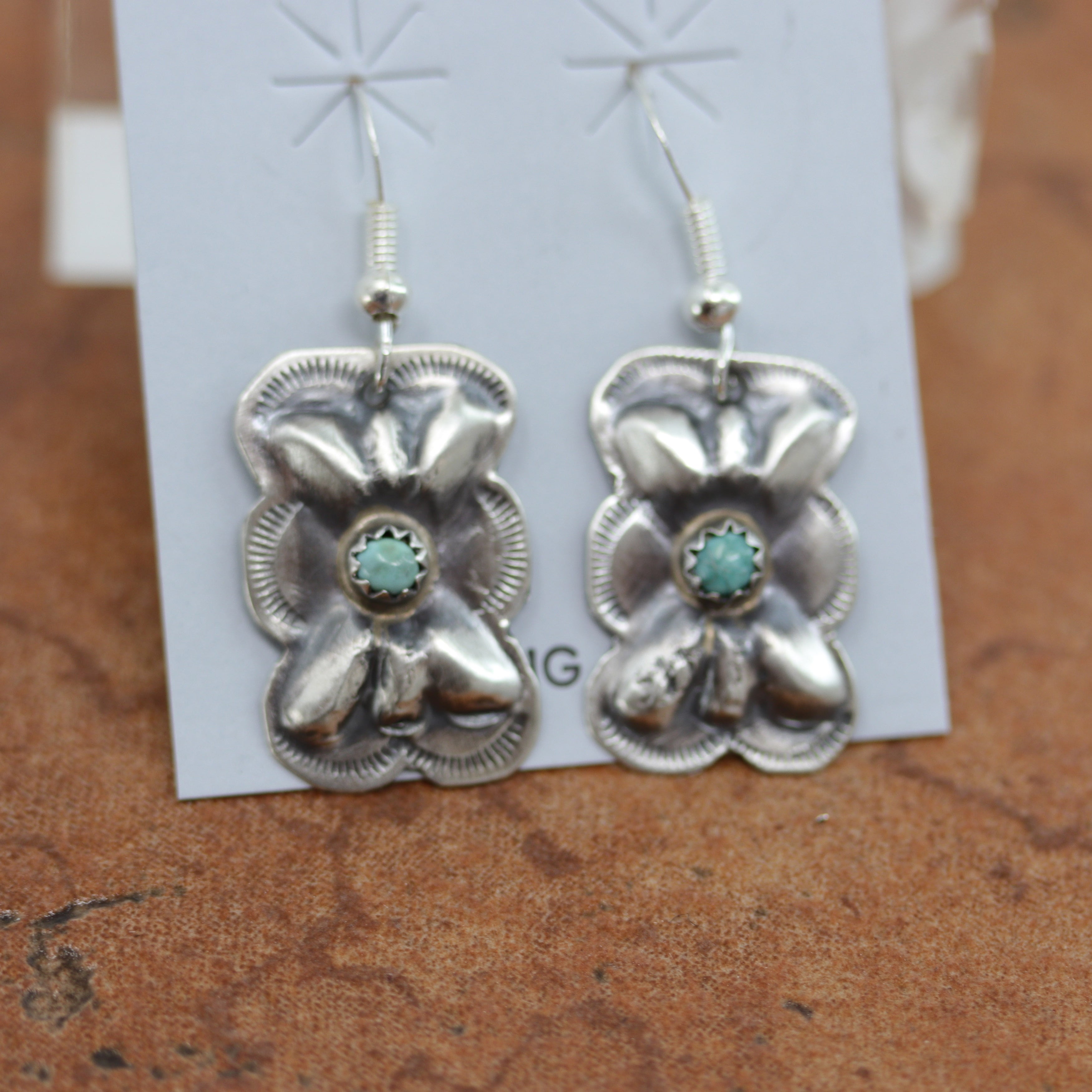 Navajo Native American earrings. They are made from sterling silver and turquoise. The earrings are 1 /2" in length including the hook and 5/8" in width.