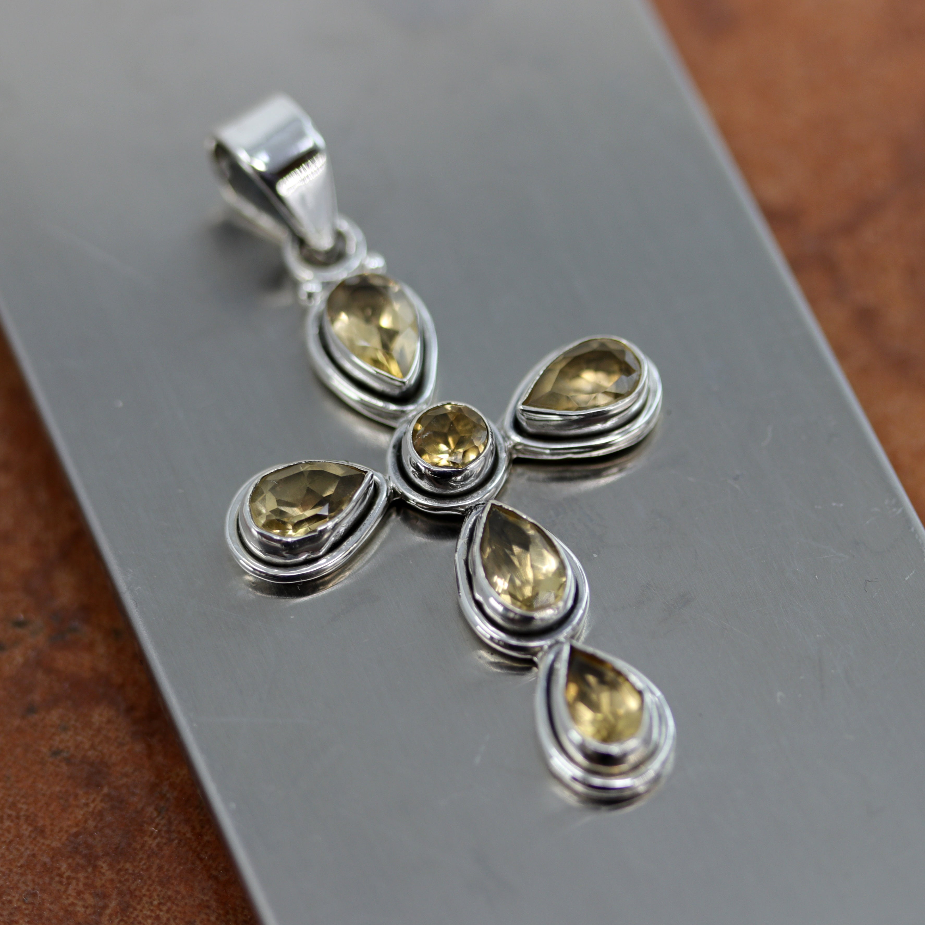 A lovely cross pendant made from Sterling Silver and citrine. It is about 2 1/8" in length including the bail, and about 1 1/4" in width.