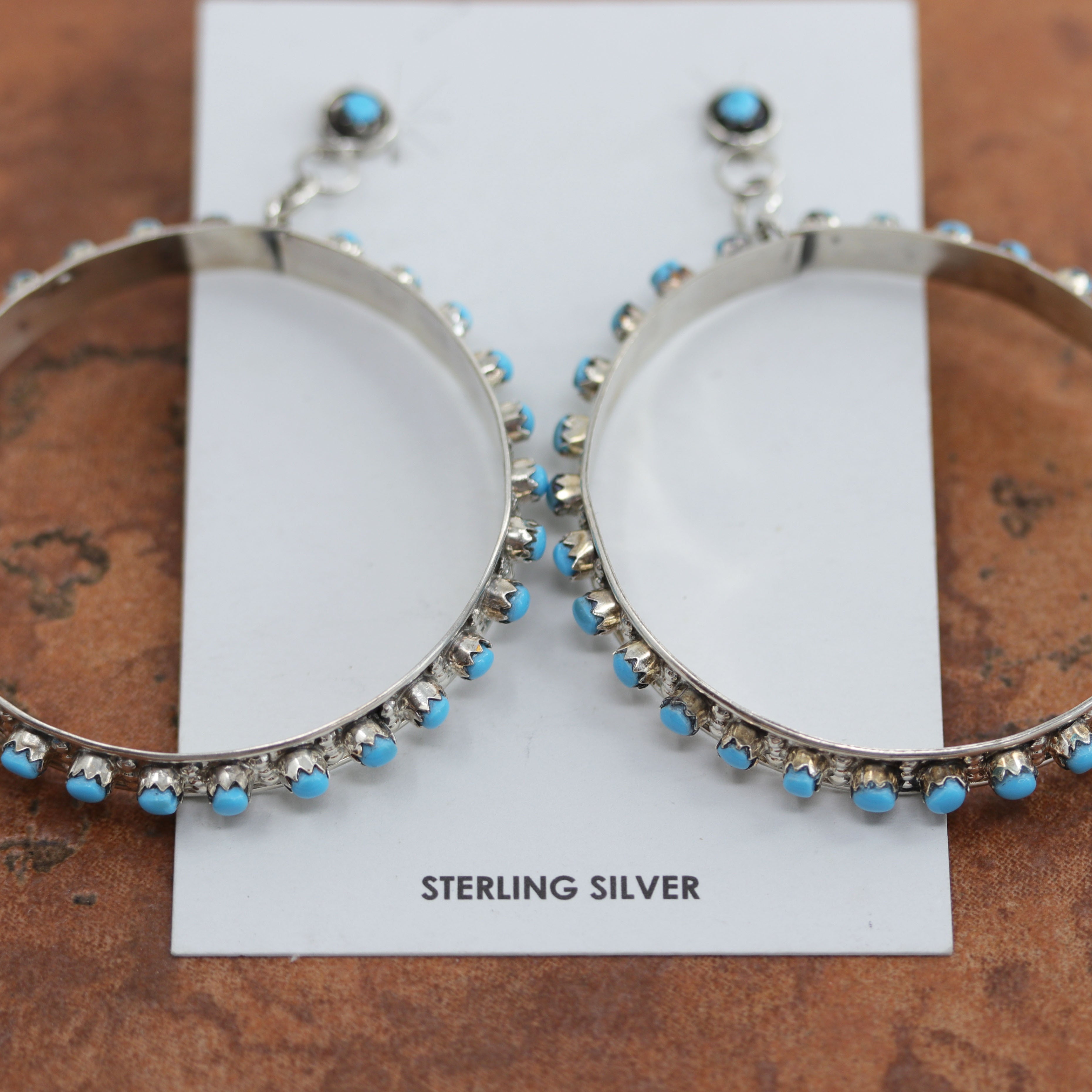 Beautiful Zuni Native American earrings. They are made from sterling silver and turquoise. Each earring is 2 7/8" in length, and about 2 1/4" in width.