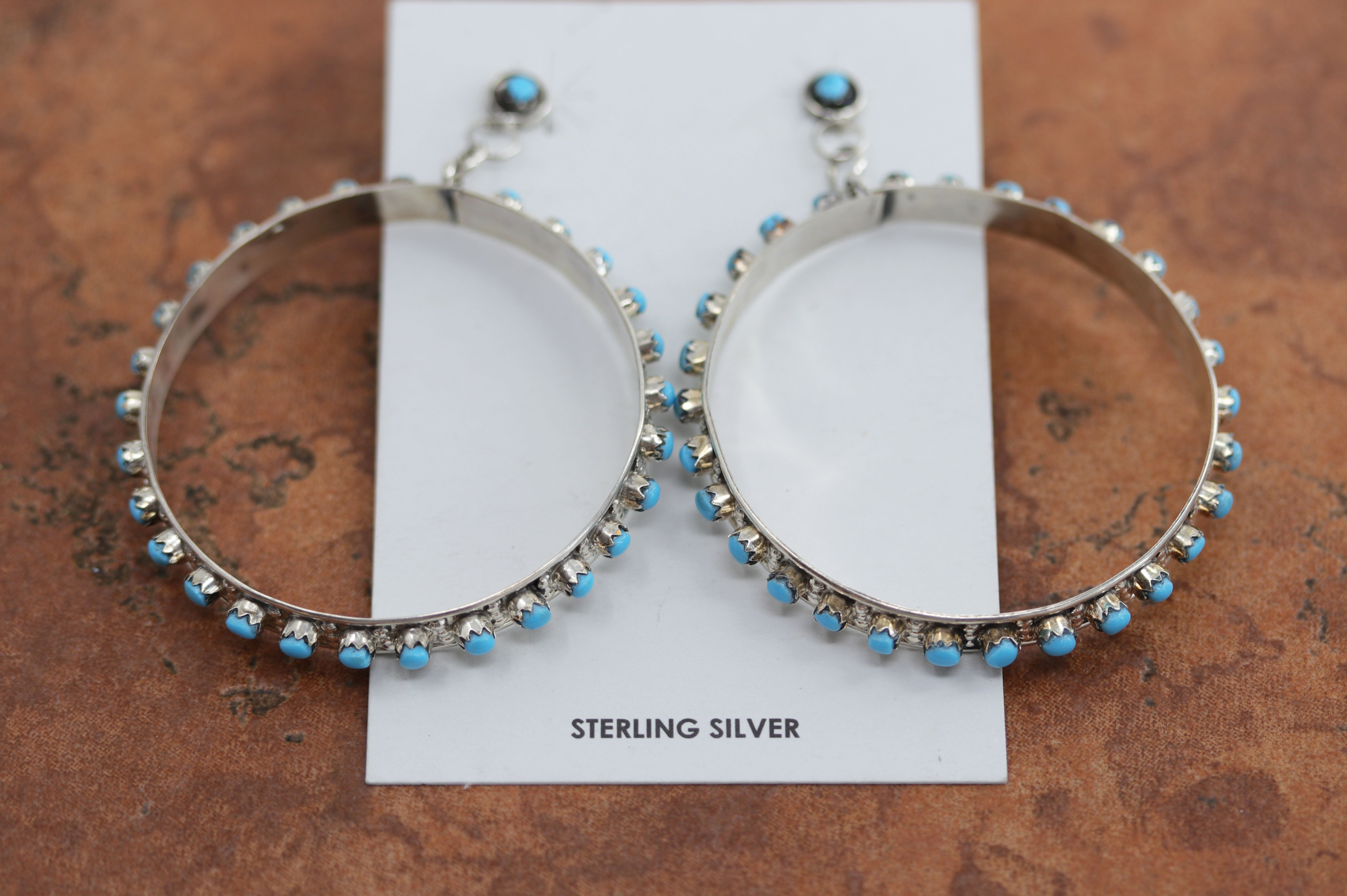Beautiful Zuni Native American earrings. They are made from sterling silver and turquoise. Each earring is 2 7/8" in length, and about 2 1/4" in width.
