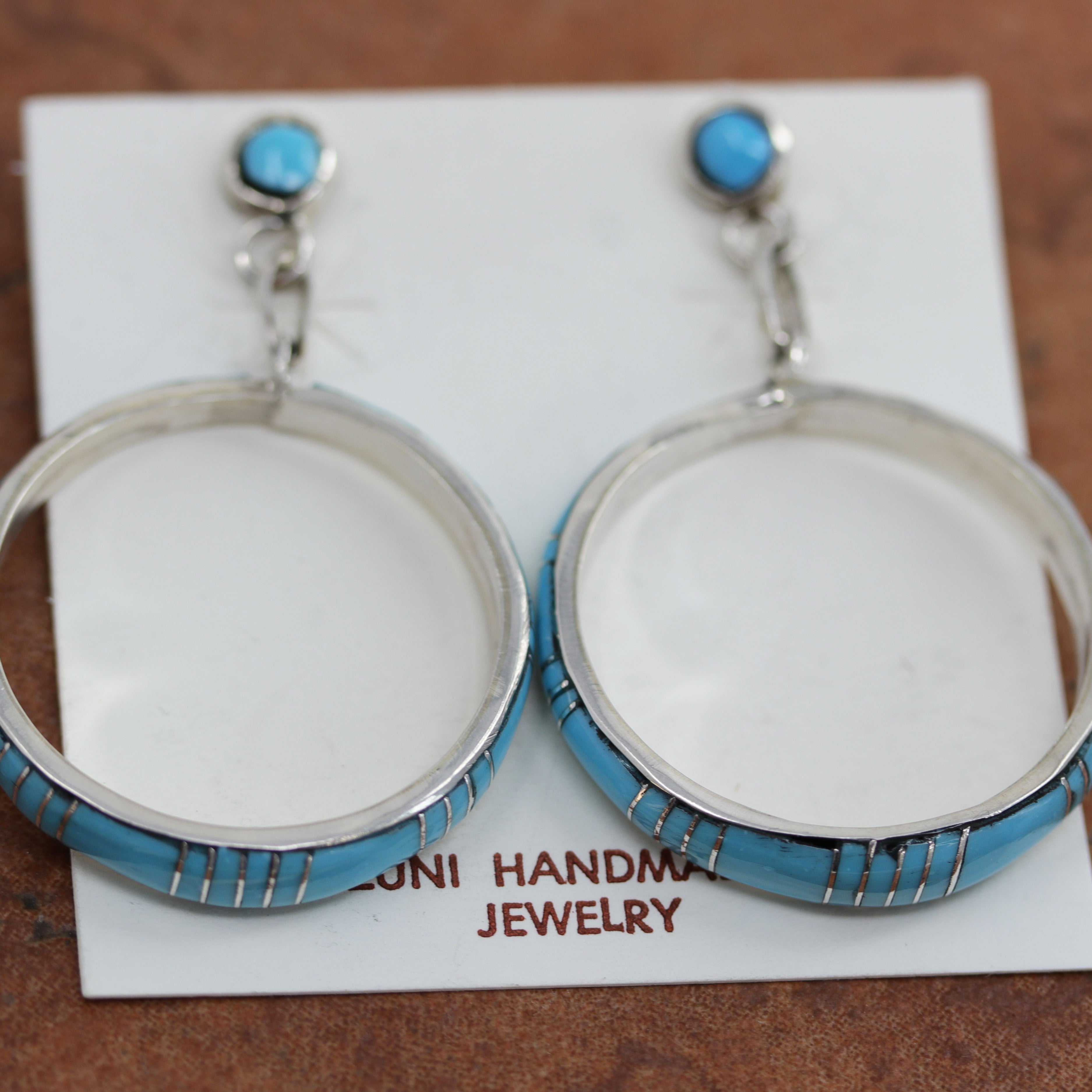 Beautiful Zuni Native American earrings. They are made from sterling silver and turquoise. Each earring is 2 1/8" in length, and about 1 3/8" in width.