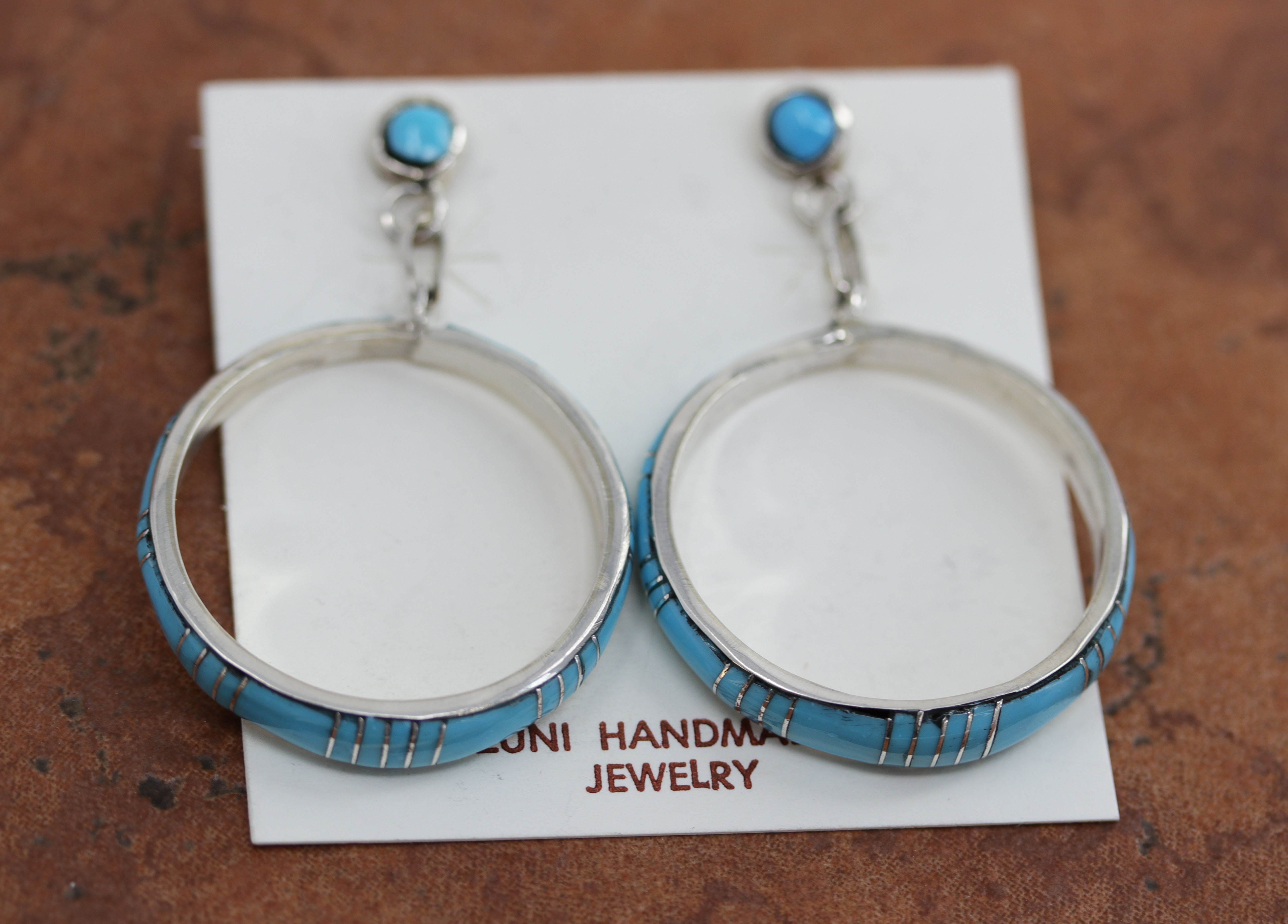 Beautiful Zuni Native American earrings. They are made from sterling silver and turquoise. Each earring is 2 1/8" in length, and about 1 3/8" in width.