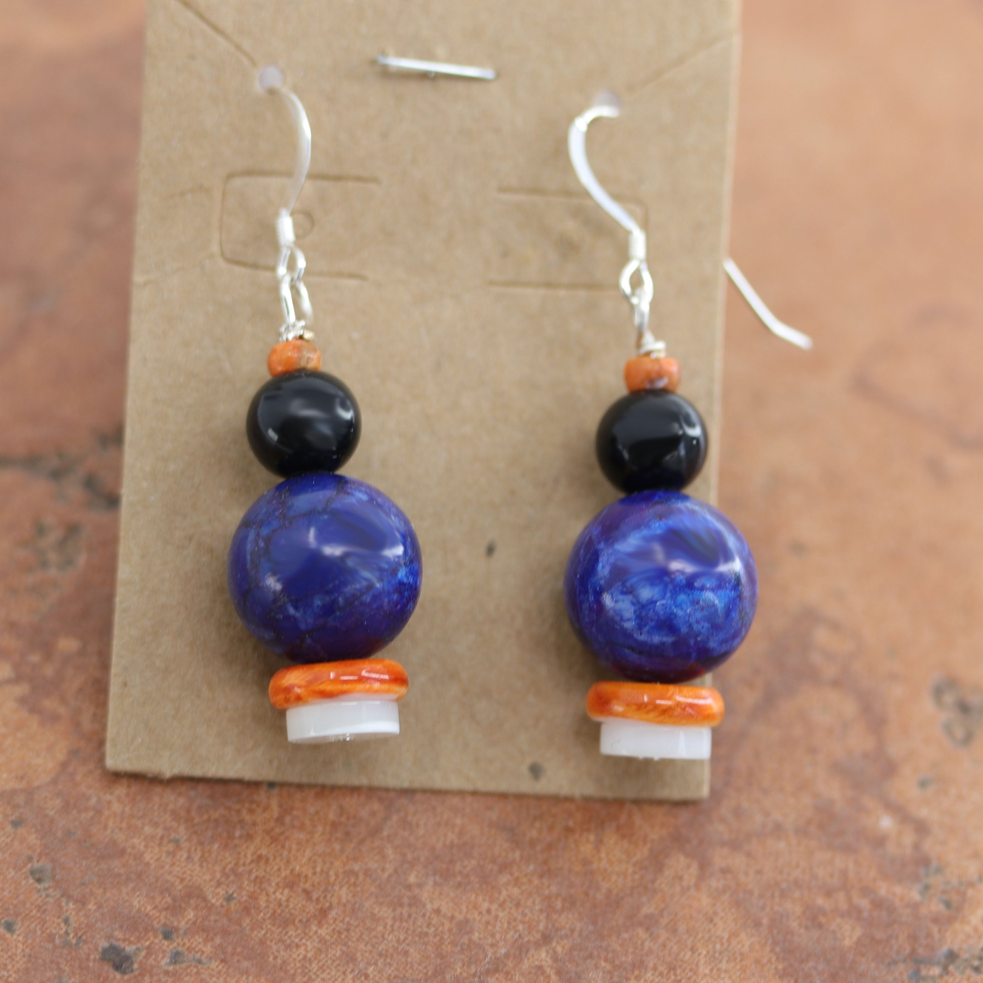 Beautiful Native American earrings made from sterling silver and various stones including lapis. The earrings are about 1 1/4" in length including the hook and 1/4" wide.