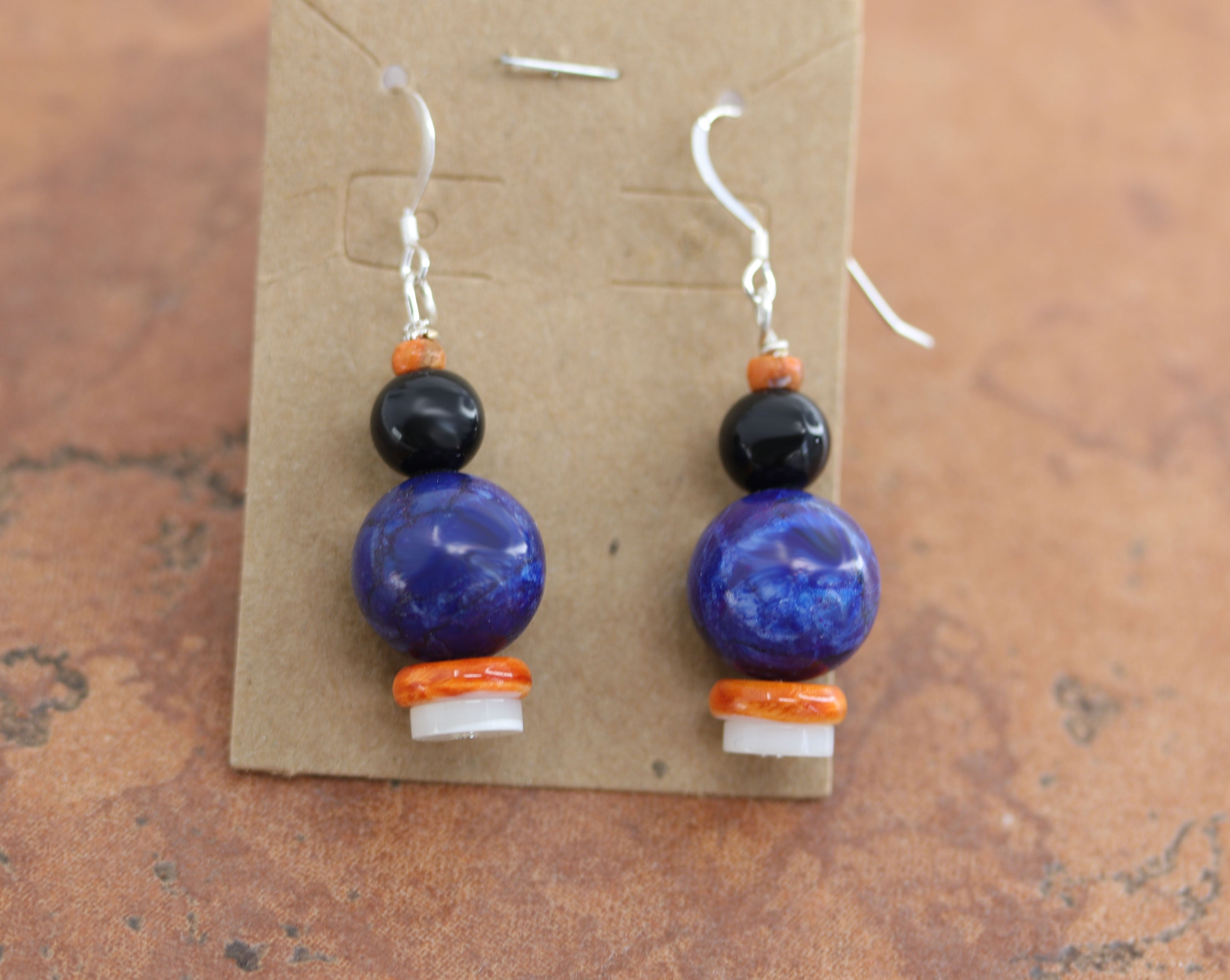 Beautiful Native American earrings made from sterling silver and various stones including lapis. The earrings are about 1 1/4" in length including the hook and 1/4" wide.