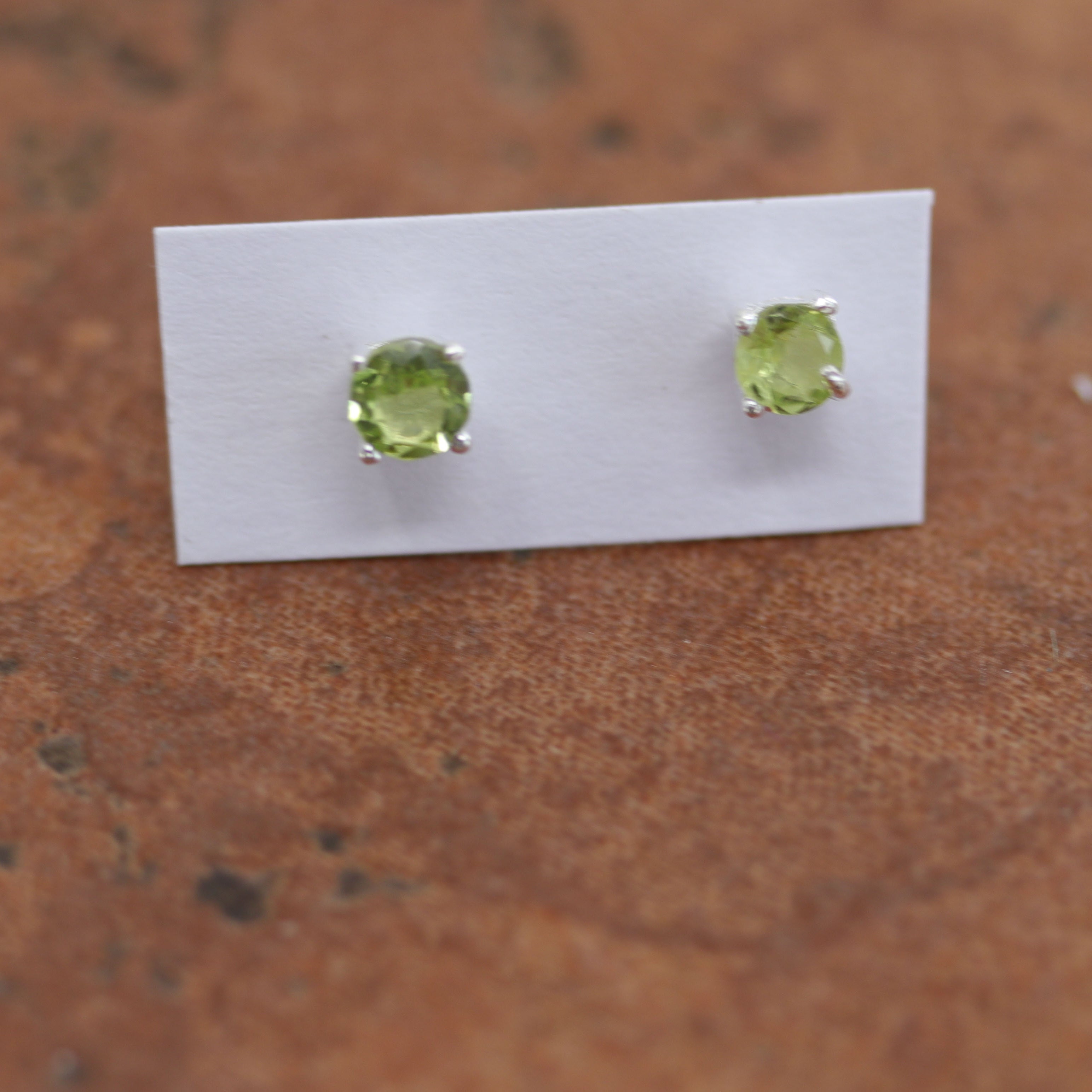Beautiful gemstone earrings made from sterling silver and genuine peridot. The earrings are 3/16" in diameter.