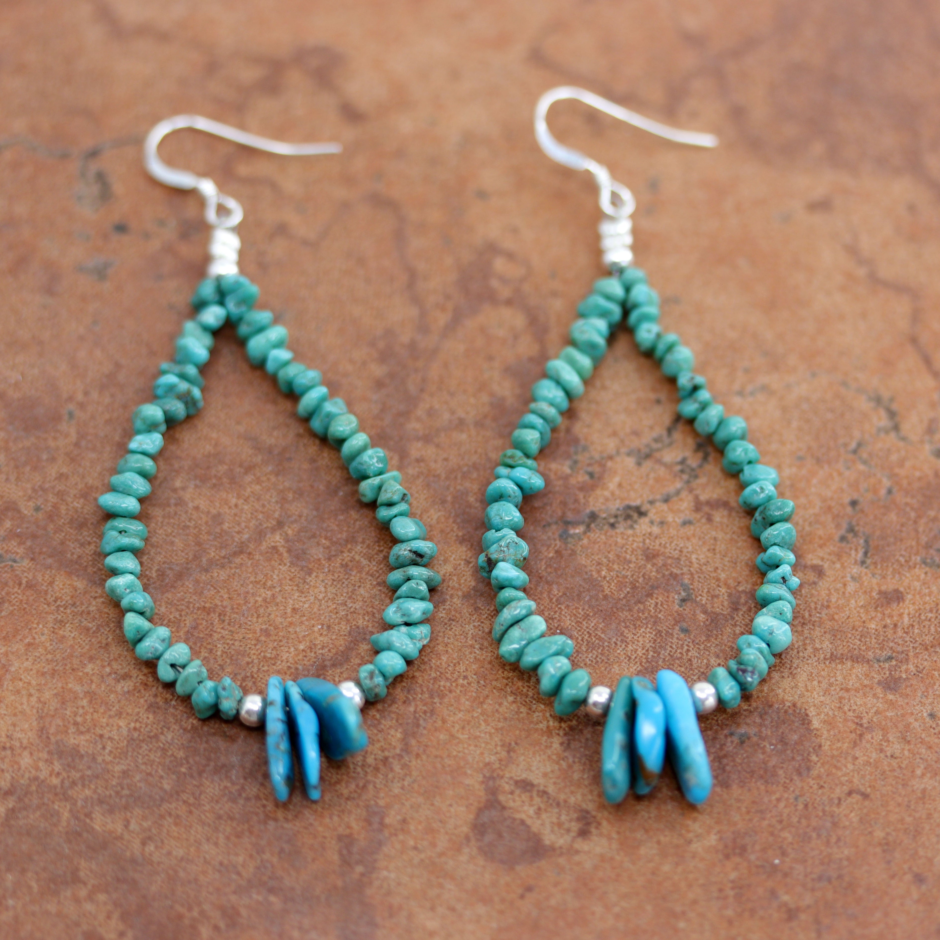 Beautiful Navajo Nugget Earrings. They are made from sterling silver and turquoise nuggets. The earrings about 3" long including the hook and the nuggets are 3/16" wide. 