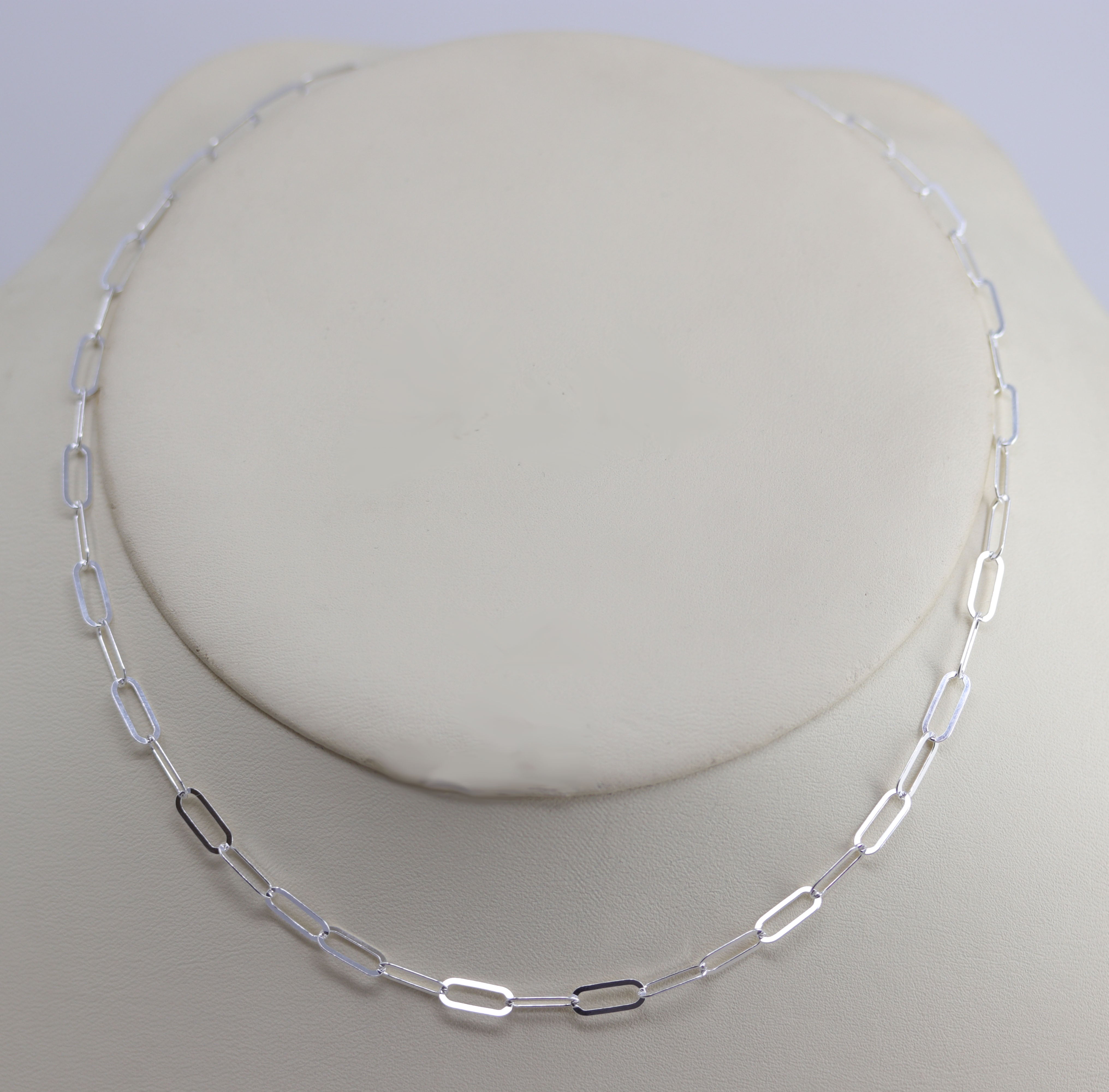 A Beautiful Paper Clip Chain Link Necklace. It is made from .925 sterling silver. The length is about 16" and the width is 3/16".