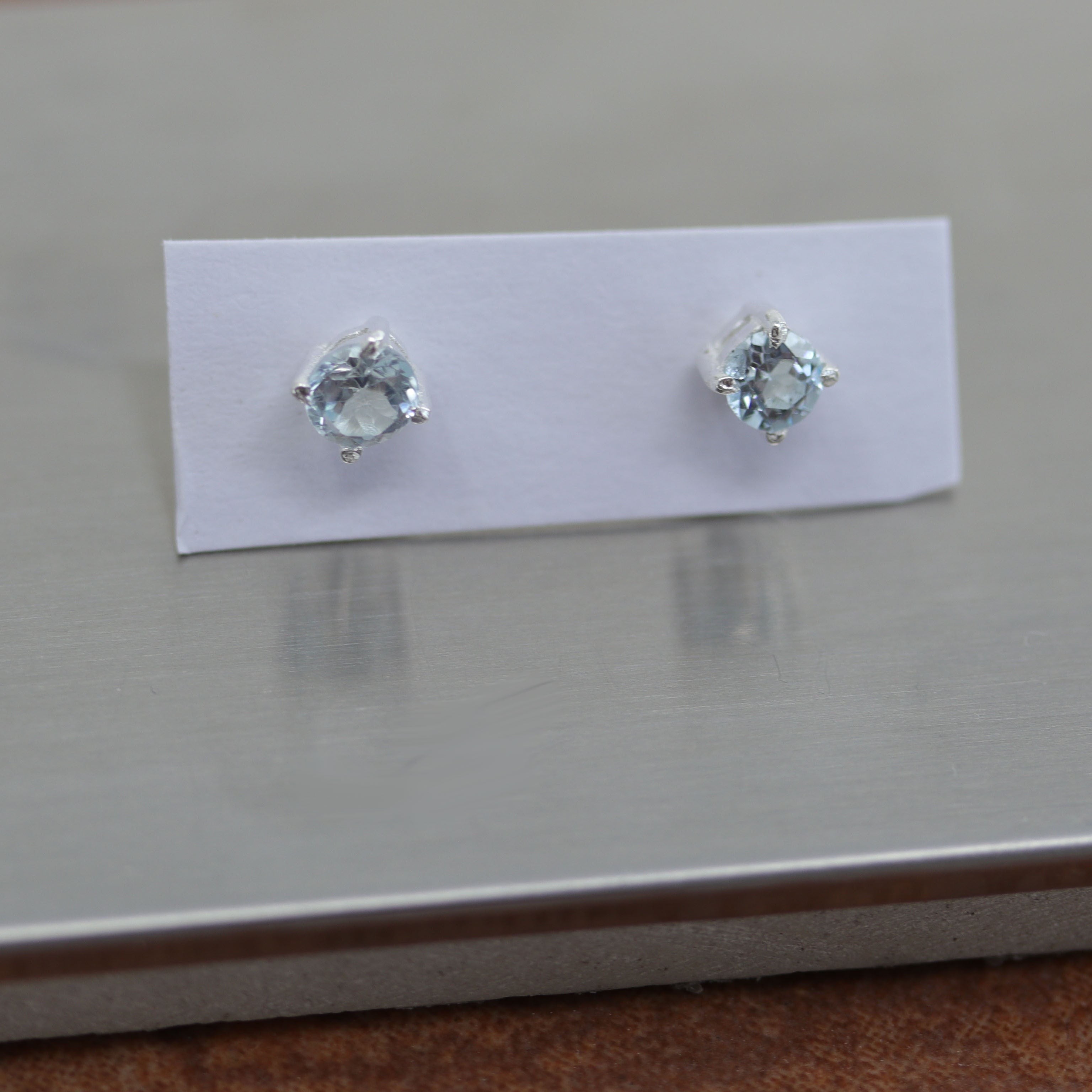 Beautiful gemstone earrings made from sterling silver and genuine aquamarine. The earrings are 3/16" in diameter.