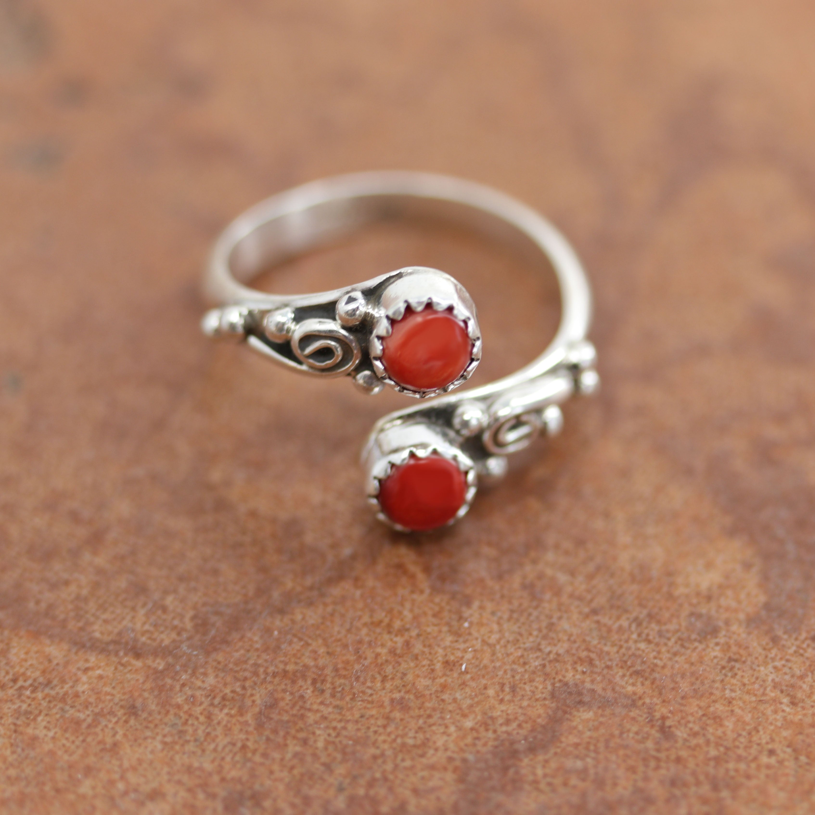 Navajo Native American ring. It is made from sterling silver and coral. The size is adjustable so it can fit sizes 10-12, and it is 5/8" at the widest point. 