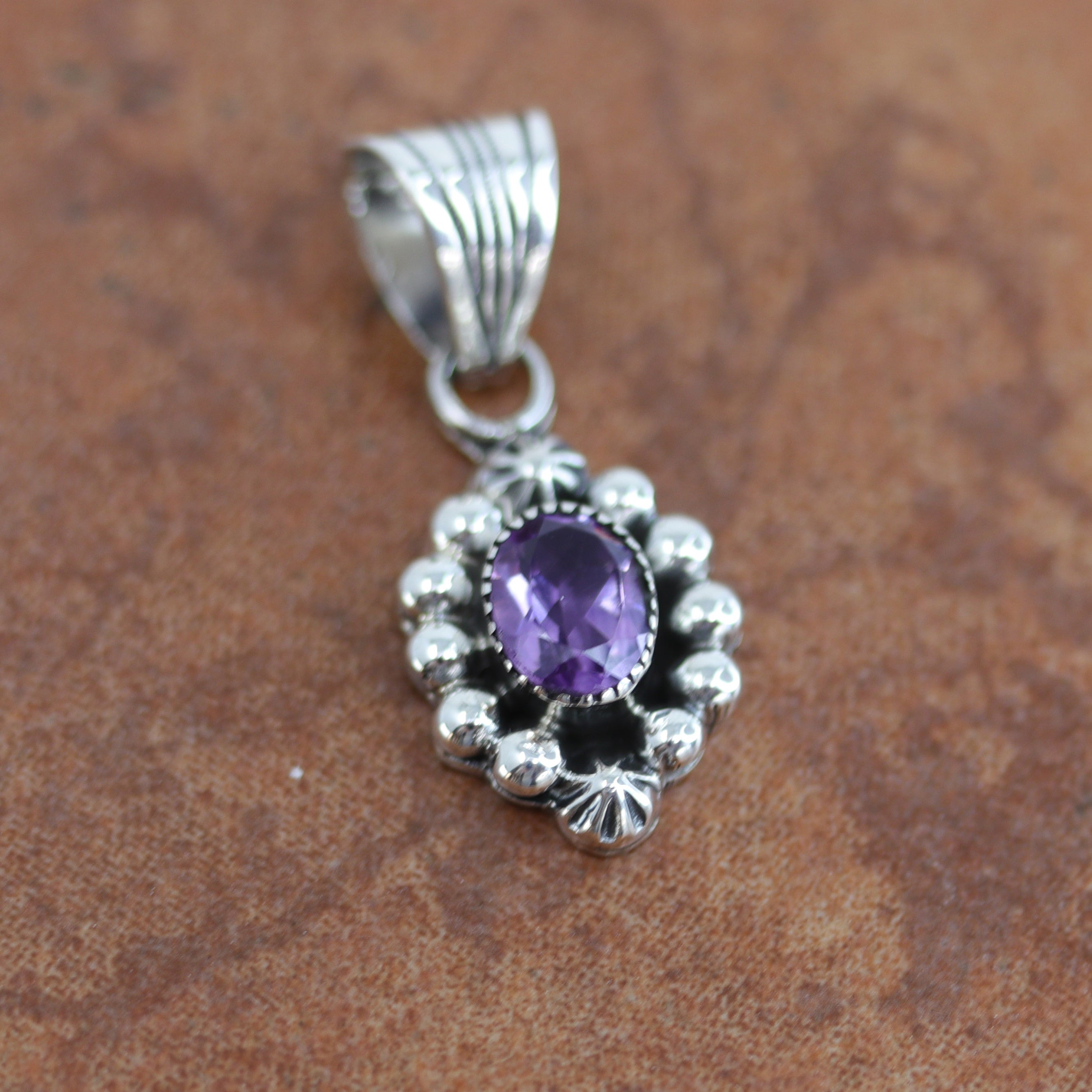 Navajo Native American Pendant by M Smith. It is made from sterling silver and amethyst. It is about 1 1/4" in length including the bail and 1/2" in width.