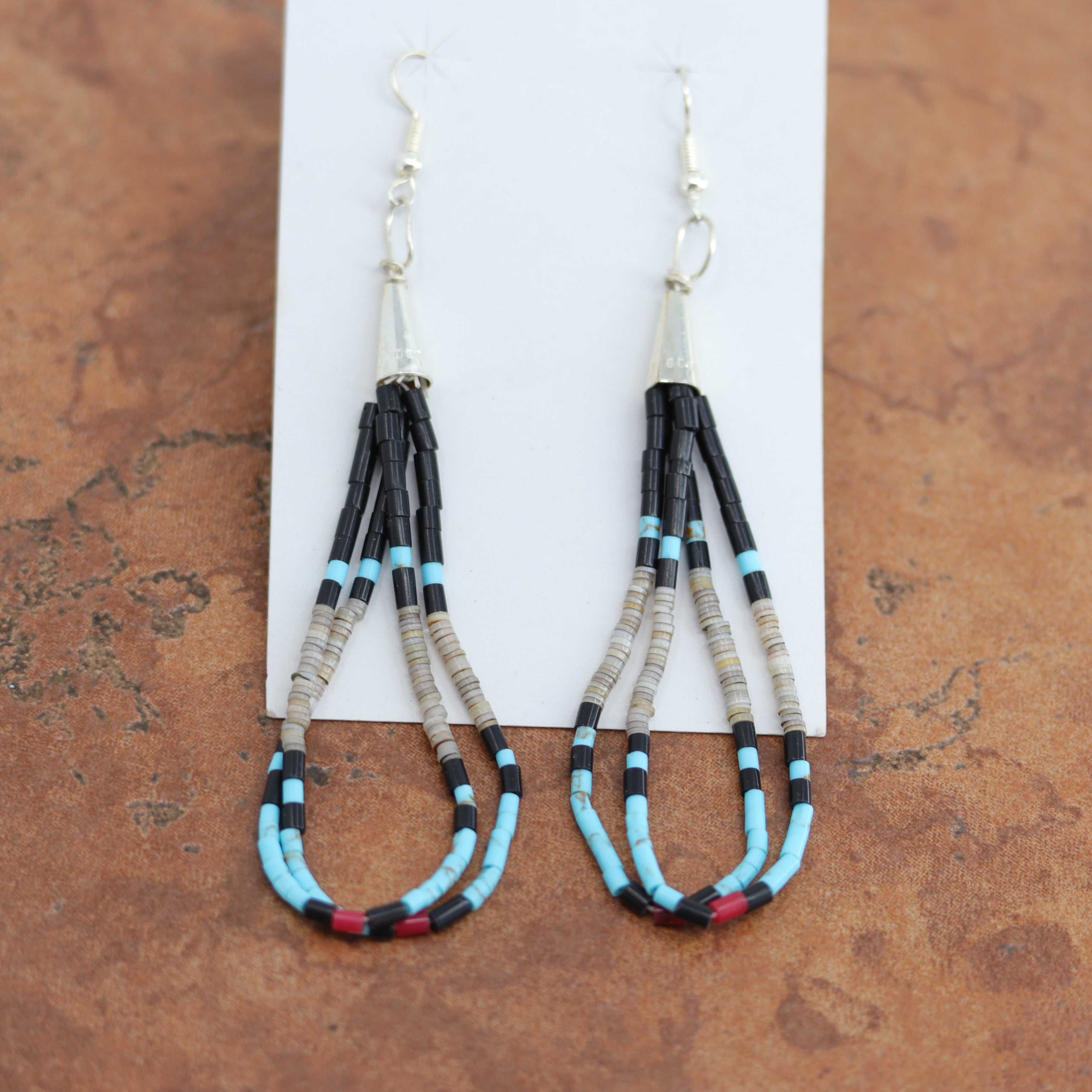 Navajo Native American silver earrings by Paul Tenorio. They are made from sterling silver. The earrings about 3 1/4" long including the hook and 1/8" in width.