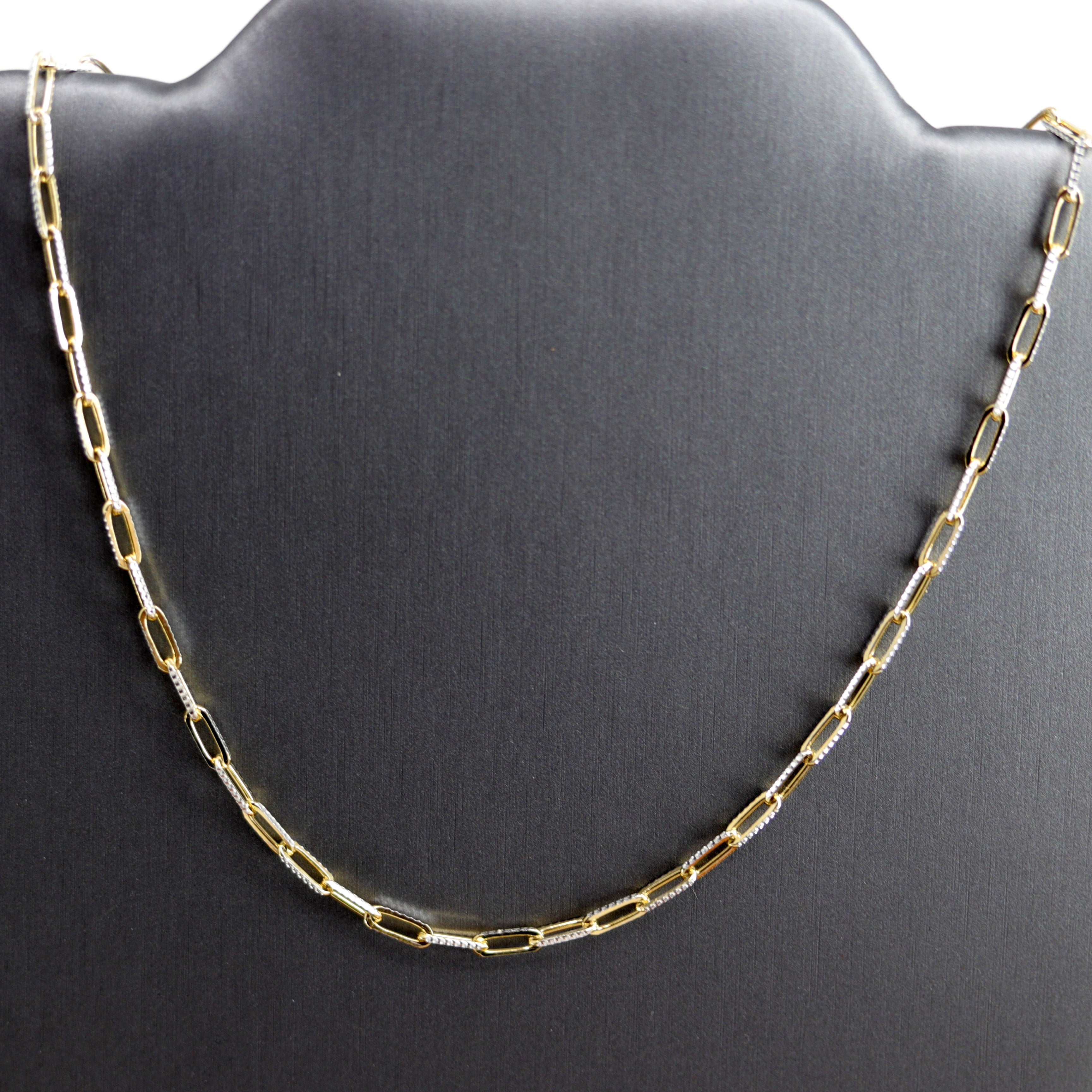 A Beautiful Paper Clip Chain Link Necklace. It is made from .925 sterling silver and gold overlay. The length is about 16" and the width is 1/8".