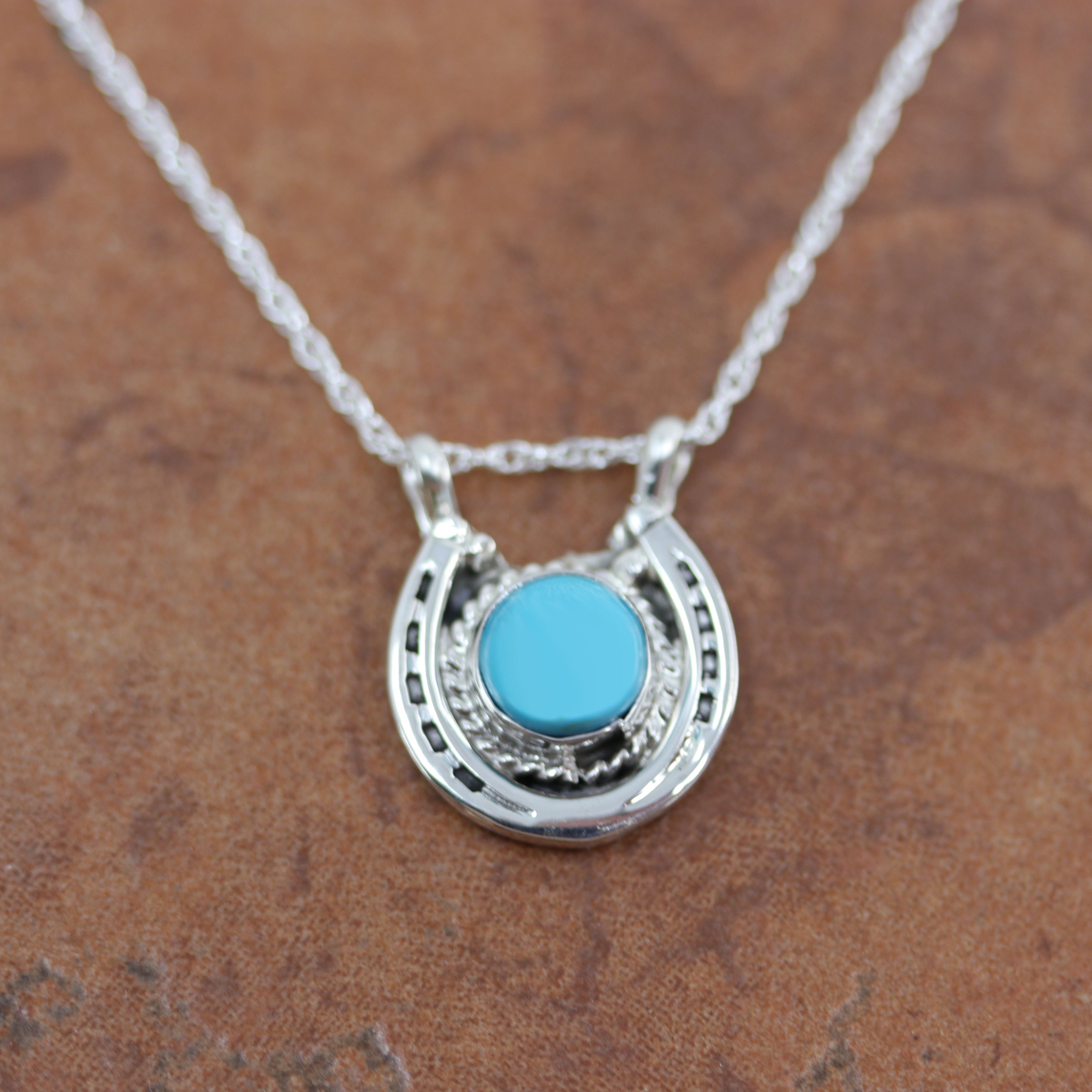 Lovely Navajo Native American Pendant. It is made from sterling silver and turquoise. It is 18" long and about 7/8" wide.