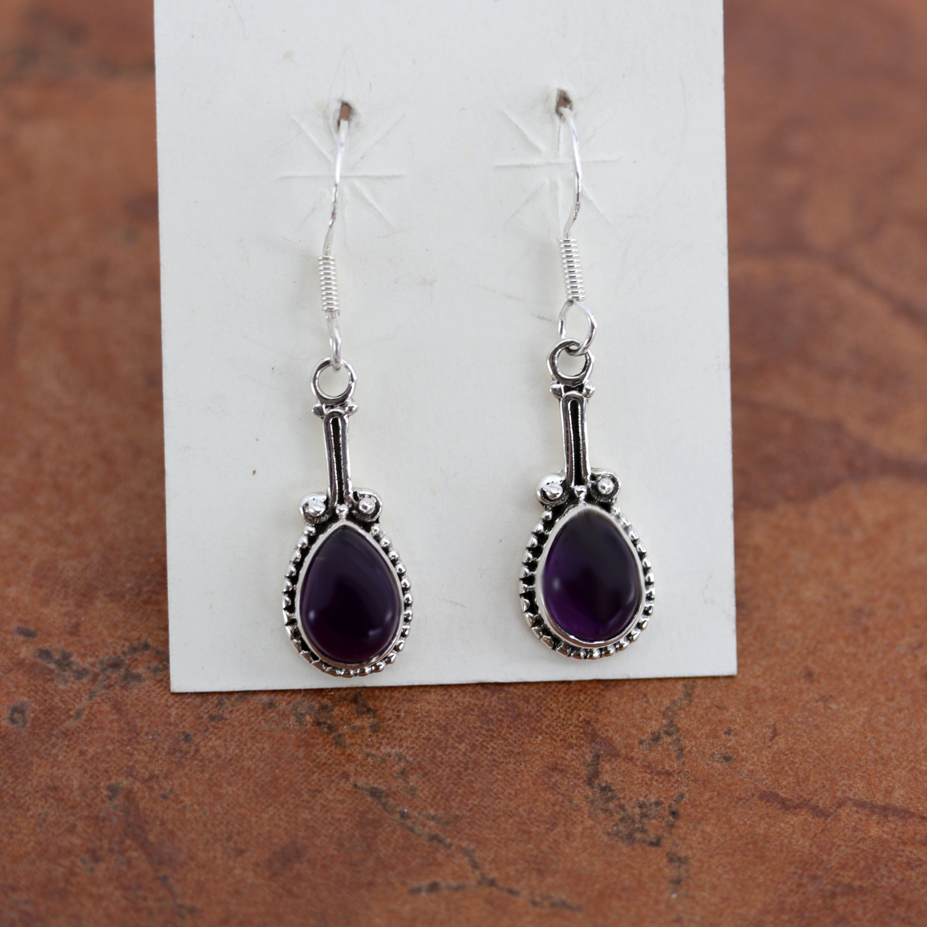 Beautiful gemstone earrings made from sterling silver and amethyst. The earrings are 1 5/8" in length including the hook and 1/2" in width.