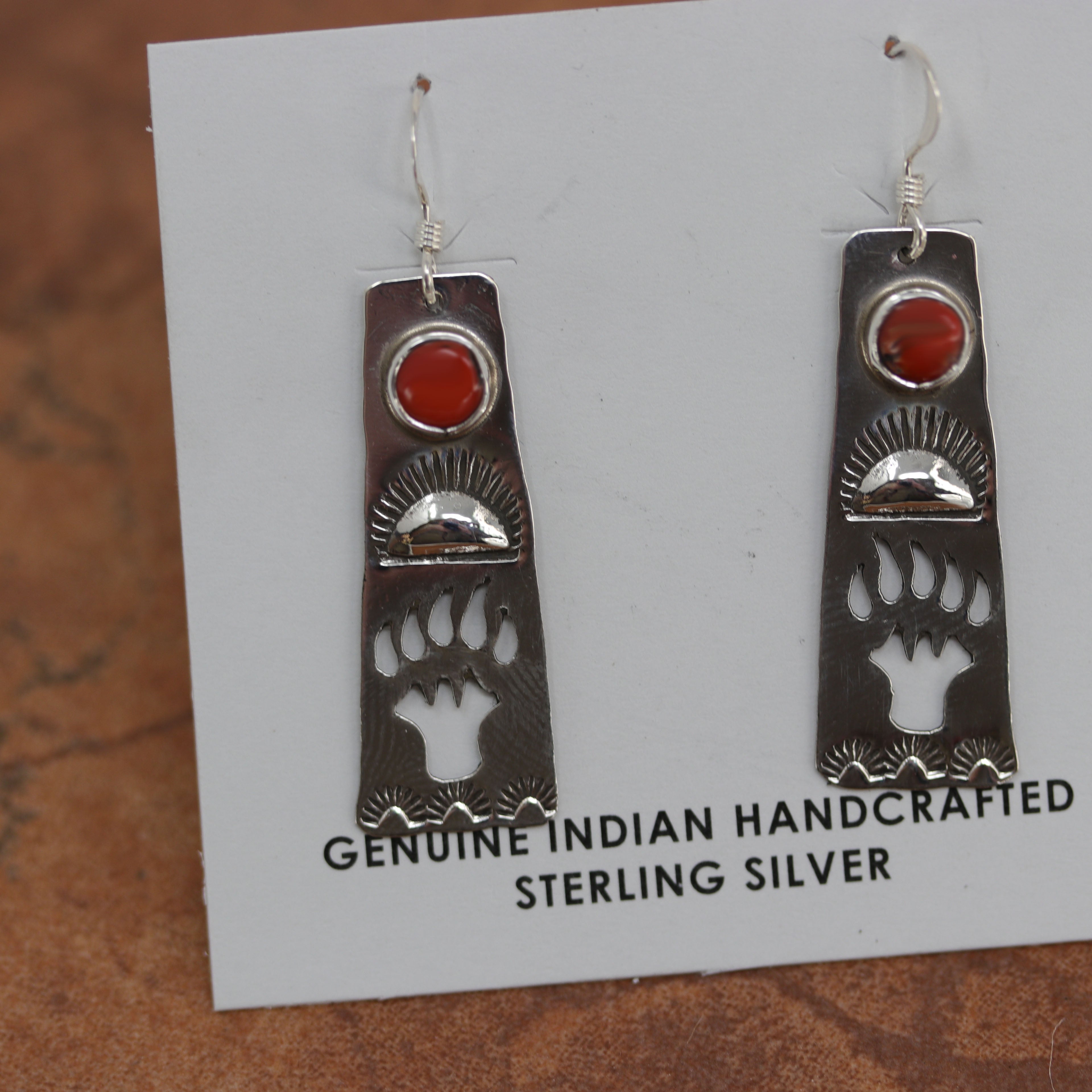 Beautiful Navajo Native American sterling silver earrings. They are made from sterling silver and coral. The earrings are about 1 3/4" in length including the hook, and about 1/2" wide.