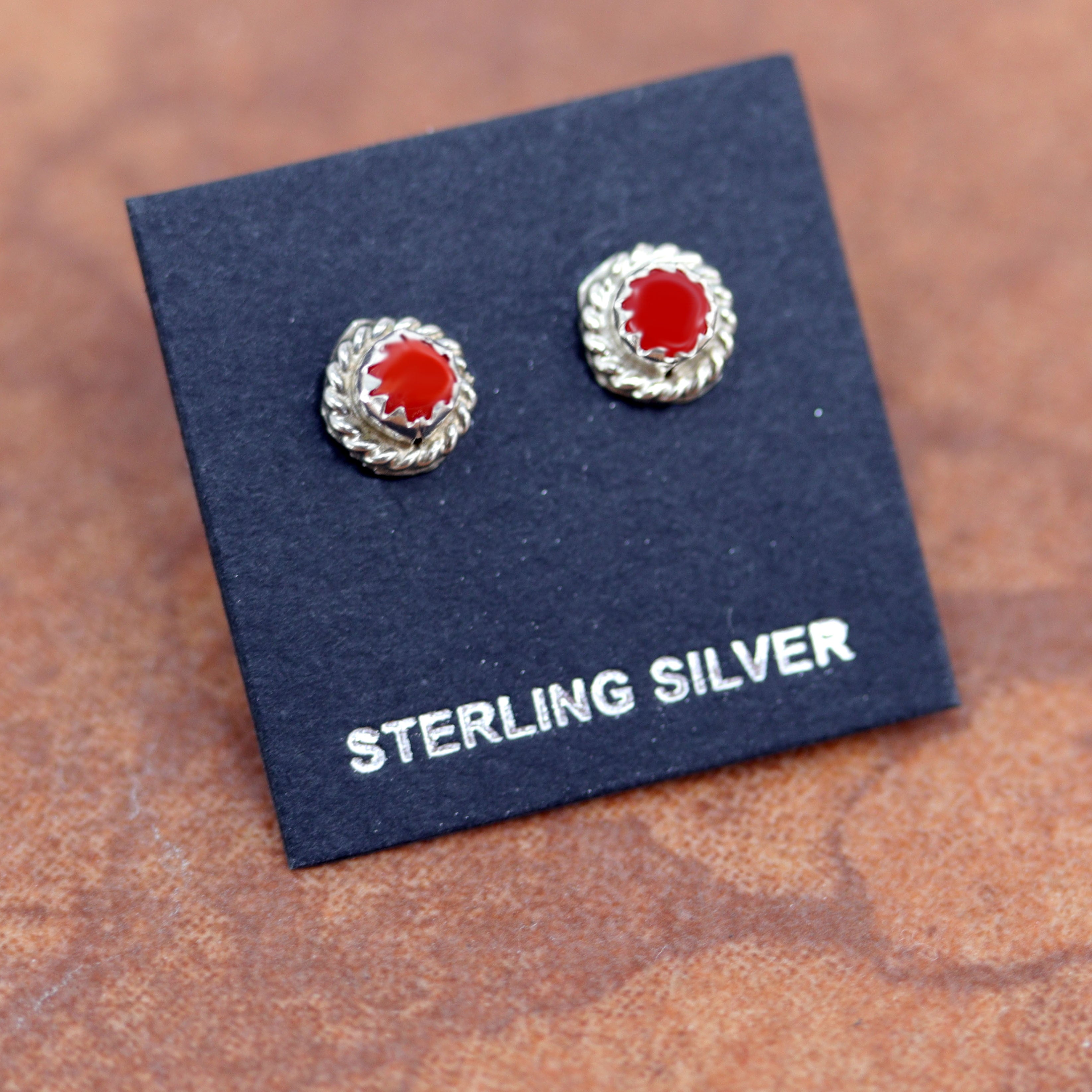 Brand new, very nice sterling silver earrings. They are made from sterling silver and coral. The earrings are about 1/4" in diameter.